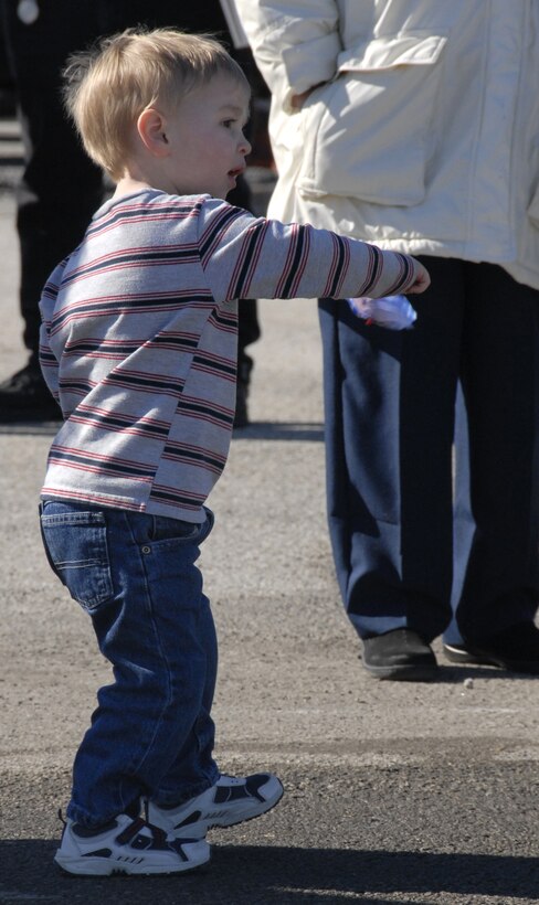 A junior-sized family member plays with a pin-wheel on the flightline at Whiteman Air Force Base, Mo., while waiting for the airplane returning approximately 30 Air Force Reservists from a six-month deployment to Iraq.  Members of the 442nd Security Forces Squadron and the 442nd Logistics Readiness Squadron were greeted by their families and friends Feb. 29, 2008.  The Citizen Airmen provided air-base ground defense and supported convoy operations from Kirkuk Air Base, Iraq.  (U.S. Air Force photo/Maj. David Kurle)