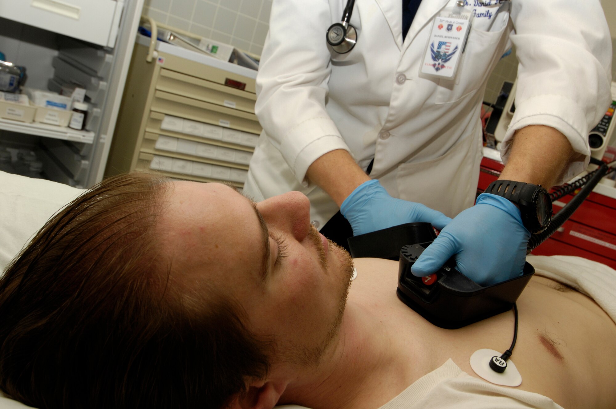 VANDENBERG AIR FORCE BASE, Calif. -- Capt. (Dr.) Daniel Rohweder, a family practice physician with the 30th Medical Group, gives a patient suffering from a simulated heart attack shock treatment during a code blue exercise on Feb. 28. Code blue is used to indicate a patient with injuries or illnesses that present an immediate life-threatening emergency, most often a cardiac arrest. The medical group has monthly training days to ensure that they are prepared for any situation that may come their way. (U.S. Air Force photo/Airman 1st Class Christian Thomas)



