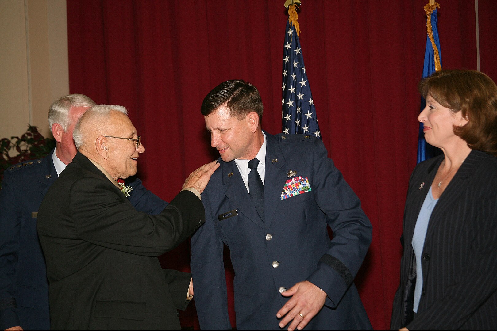 Brig. Gen. Len Patrick, 37th Training Wing commander, gets his star embedded into his uniform by his father, Alexander "A.J." Patrick, a retired senior master sergeant and Vietnam veteran, during the general's frocking ceremony Feb. 20. General Patrick took command of the 37th TRW Jan. 25. Special guests at the ceremony included Gen. and Mrs. Bill Looney, Air Education and Training Command commander; Louis Stumberg, civilian aide emeritus to the secretary of the Army, and Col. David Orr, 2nd Air Force vice commander. (USAF photo by Robbin Cresswell)