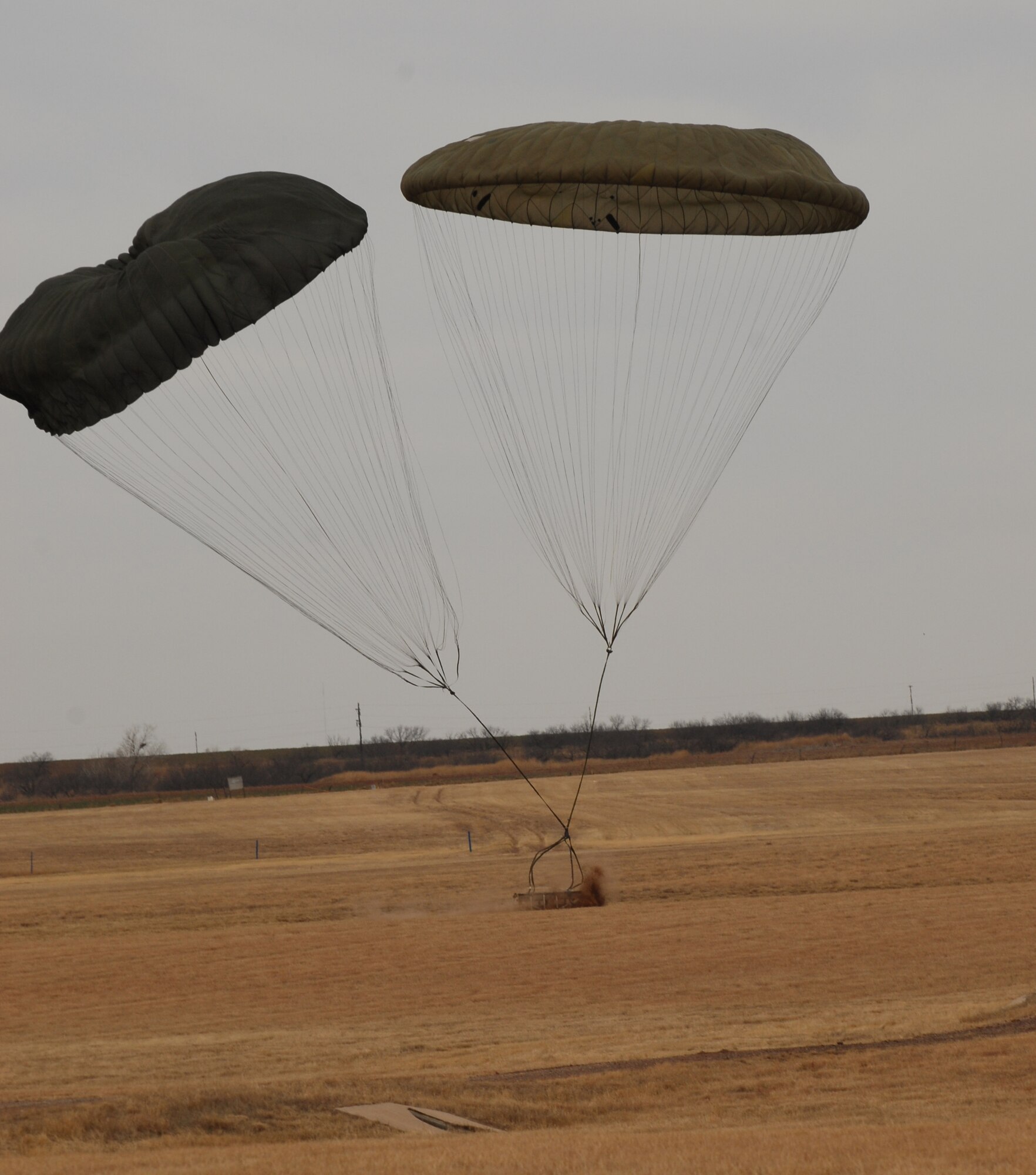 ALTUS AIR FORCE BASE, Okla. -- A cargo pallet lands inside the drop zone during a C-17 Globemaster III airdrop exercise at Duke, Okla., Feb. 28. Duke is aproximately 17 miles west of Altus. (U.S. Air Force Photo/Airman 1st Class Rebecca Talley)