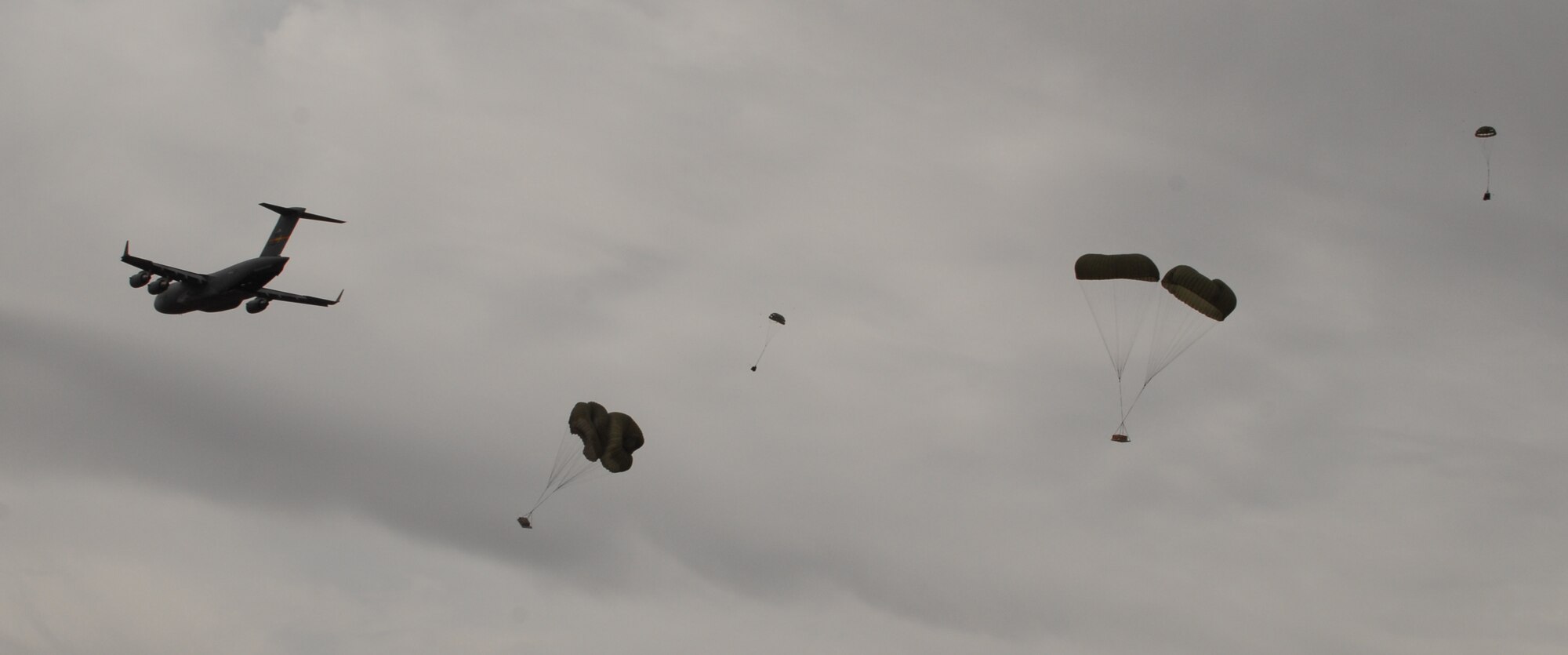 ALTUS AIR FORCE BASE, Okla. -- An Altus AFB C-17 Globemaster III drops his load of cargo pallets over the drop zone during an airdrop exercise at Duke, Okla., Feb. 28. Two C-17s dropped several pallets during the exercise. Through these exercise, Altus AFB trains the Air Force's next generation of C-17 pilots and loadmasters. (U.S. Air Force Photo/Airman 1st Class Rebecca Talley)