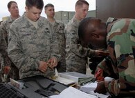 MOODY AIR FORCE BASE, Ga. -- Airman 1st Class Skyler Callender, 723rd Aircraft Maintenance Squadron HH-60G Pave Hawk crew chief, checks and recieves weapons from Airman 1st Class Cedric Lewis, 23rd Logistics Readiness Squadron, here March 22.  The 723rd AMXS recently left for Iraq in support of Operation Iraqi Freedom. (U.S. Air Force photo by Senior Airman Schelli Jones)