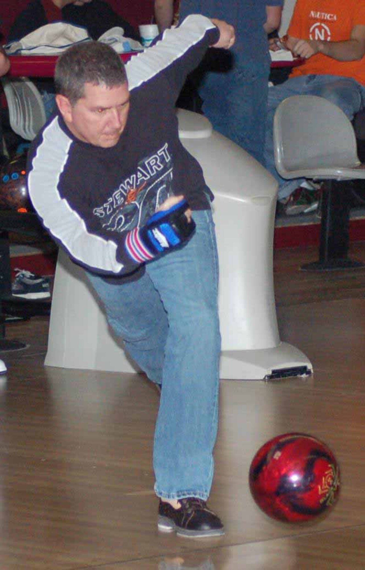 552nd Aircraft Maintenance Squadrpm  bowler Mike Cumella rolls a strike in game one against the 552nd Communications Group at the Tinker Bowling Center on Feb 20. The 552nd AMXS won the match 3156-3132.  (Air Force photo by John E. Banks)