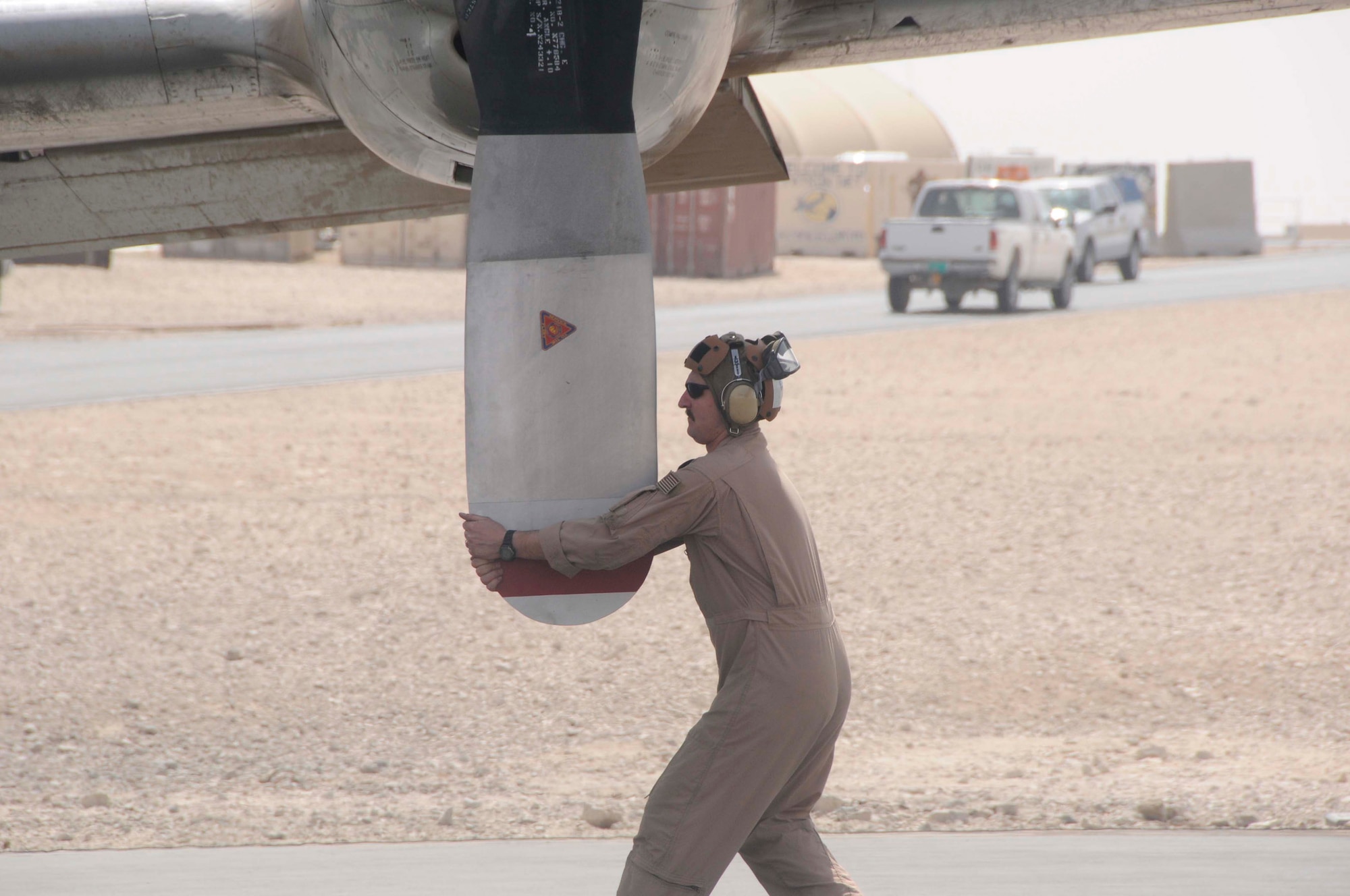 Navy aircraft structural mechanic 1st Class Leo Mackin spins a propeller as part of a pre-flight check Feb 26 at an air base in Southwest Asia. Checks are done on each of the four propellers for nicks, scratches and cracks prior to take off. The Navy members are stationed on the air base in support of battlespace surveillance missions. (U.S. Air Force photo/Senior Airman Domonique Simmons) 