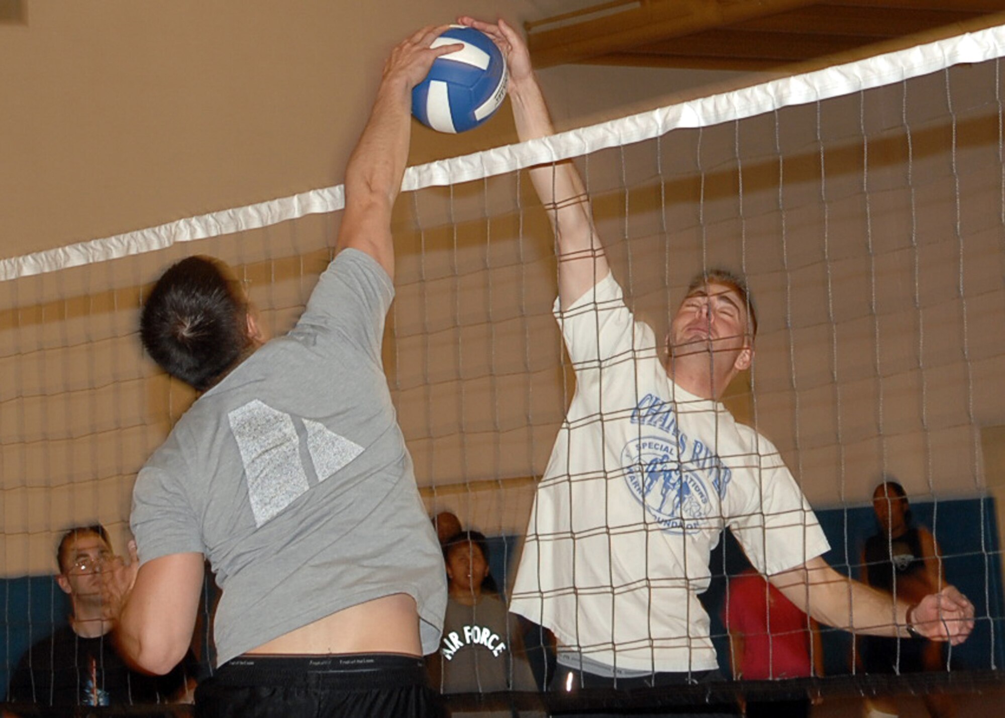 CANNON AIR FORCE BASE, N.M. -- Senior Airman Bradley Luu, 27th Special Operations Communication Squadron, blocks 2nd Lt. Stephen Woskov, 27th Special Operations Communication Squadron, during the Company Grade Officer, Airman Leadership School class 2008-D volleyball game. Each ALS class competes against the CGOs in a sporting event allowing the officers to interact with the upcoming non commisoned officers. (U.S. Air Force photo by Airman Basic Danielle Martin)