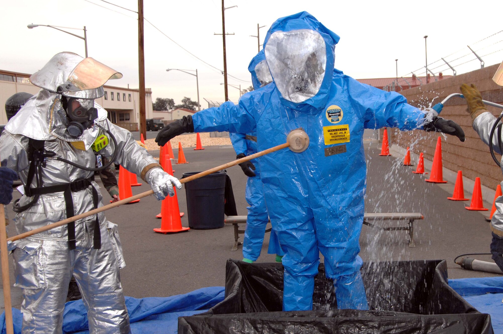 Fire Fighters decontaminate a Hazardous Materials team member during the Home Station Attack Response Exercise Feb. 21. The exercise evaluated the wing’s ability to execute the Comprehensive Emergency Management Plan in response to a terrorist’s use of various weapons. (U.S. Air Force photo/Nan Wylie)
