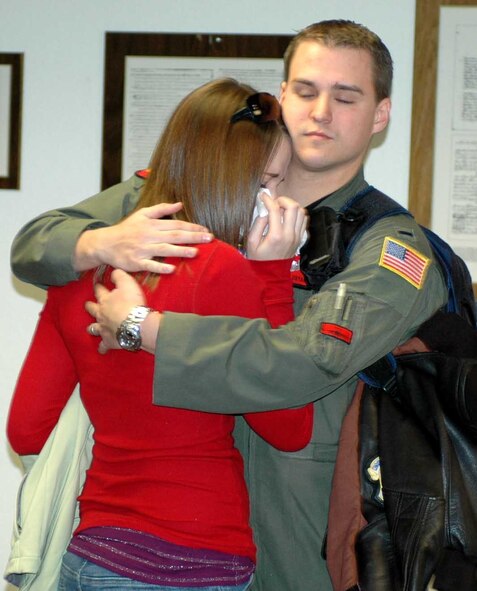 1st Lt. David Floryan, 21st AS pilot, hugs his wife Amber at Travis’ passenger terminal Feb. 27 before leaving on the squadron’s first-ever collective deployment in support of the Global War on Terrorism. (U.S. Air Force photo/Tech. Sgt. Matthew McGovern)