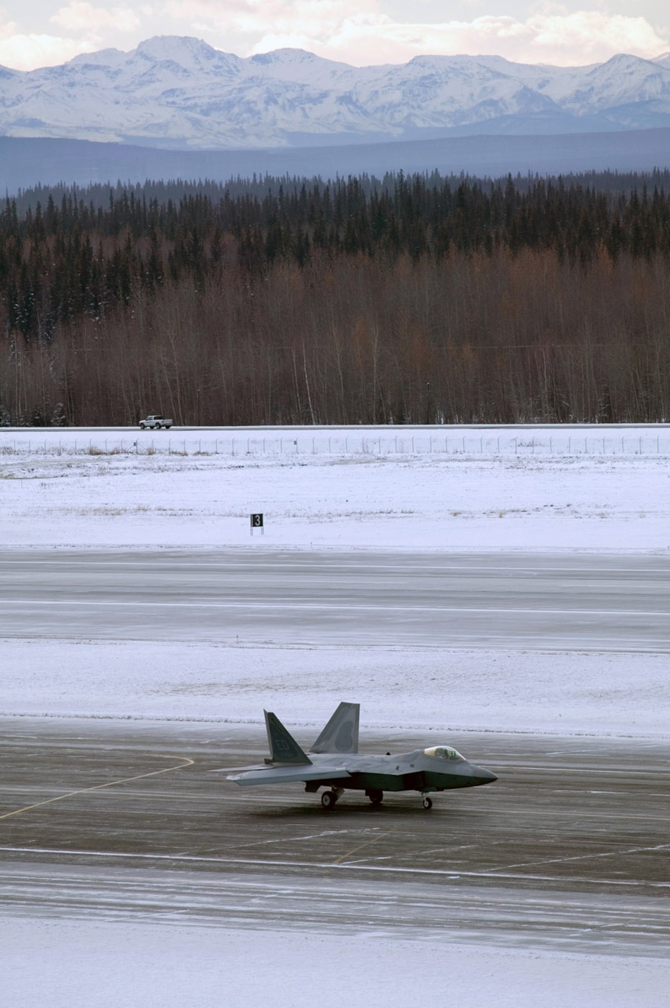 An F-22 Raptor performs manuevering, stopping and going on low runway conditions Nov. 7 at Eielson AFB, Alaska. The F-22 underwent cold-weather testing on its braking system. (U.S. Air Force photo by Kevin Roberston) 
