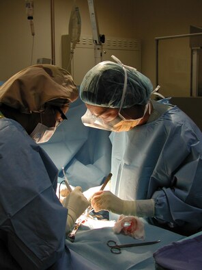 After rushing him into surgery, Maj. Dr.) Crystine Lee and her team remove bacterially infected tissue from Staff Sg. Stephen Jones' leg. The sergeant developed necrotizing fasciitis, also known as flesh-eating bacteria. while deployed to southwest asia. This type of infection is fatal if not treated immediately (U.S. Air Force photo by 1st Lt. Sara Lanin)