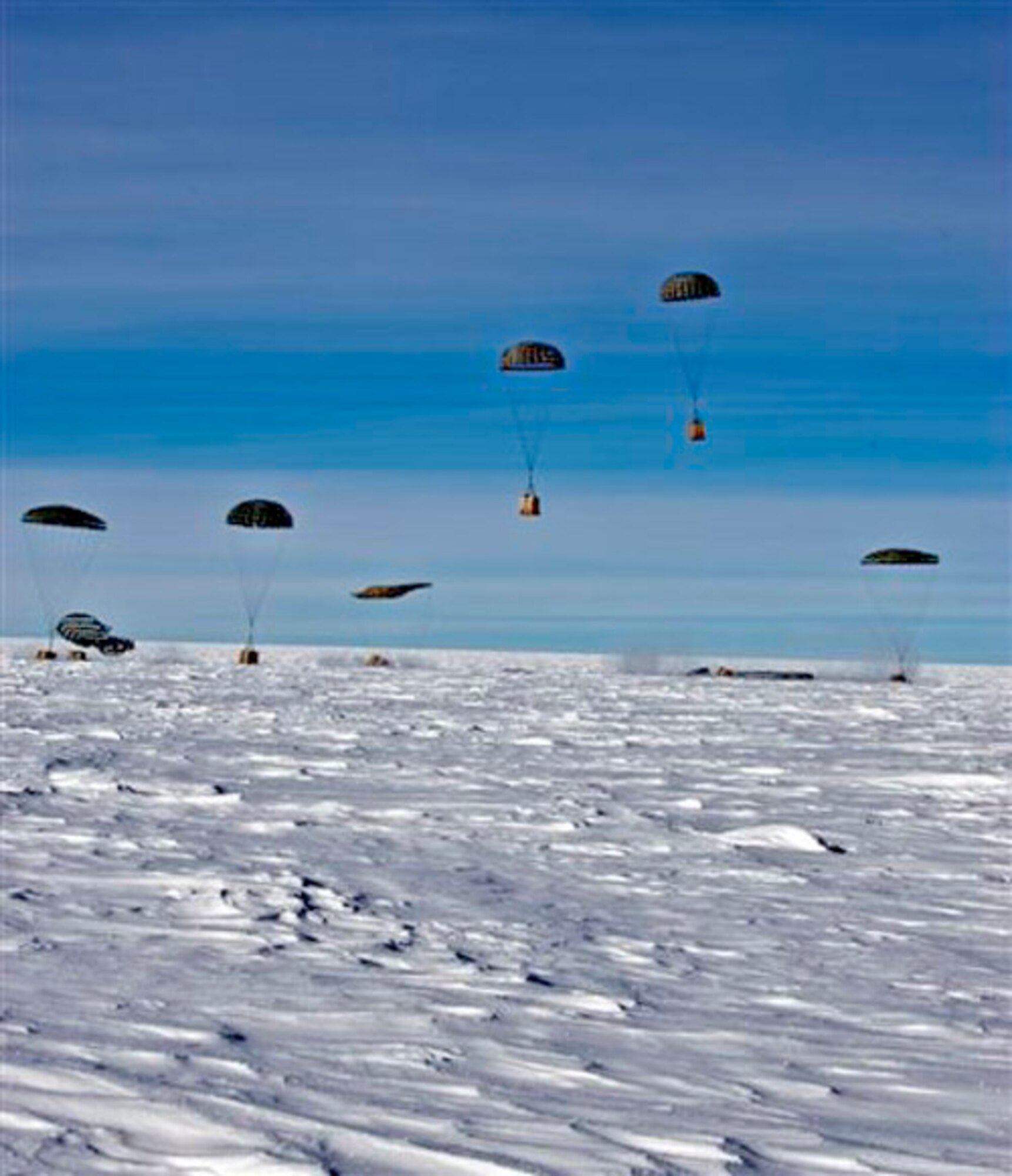 Containerized delivery system bundles are recovered by a ground crew member at the South Pole. The bundles were airdropped by a McChord Air Force Base, Wash., C-17 Globemaster III supporting Operation Deep Freeze. The 13th Air Force-led Operation Deep Freeze is a unique joint and total force mission that has supported the National Science Foundation and U.S. Antarctic Program since 1955. By validating the C-17's capability to complete airdrop missions at the geographical South Pole, Joint Task Force-Support Forces Antarctica demonstrated its ability to provide mid-winter emergency re-supply and flexible support to the National Science Foundation and U.S. Antarctica Program. (Courtesy photo/B.K. Grant) 