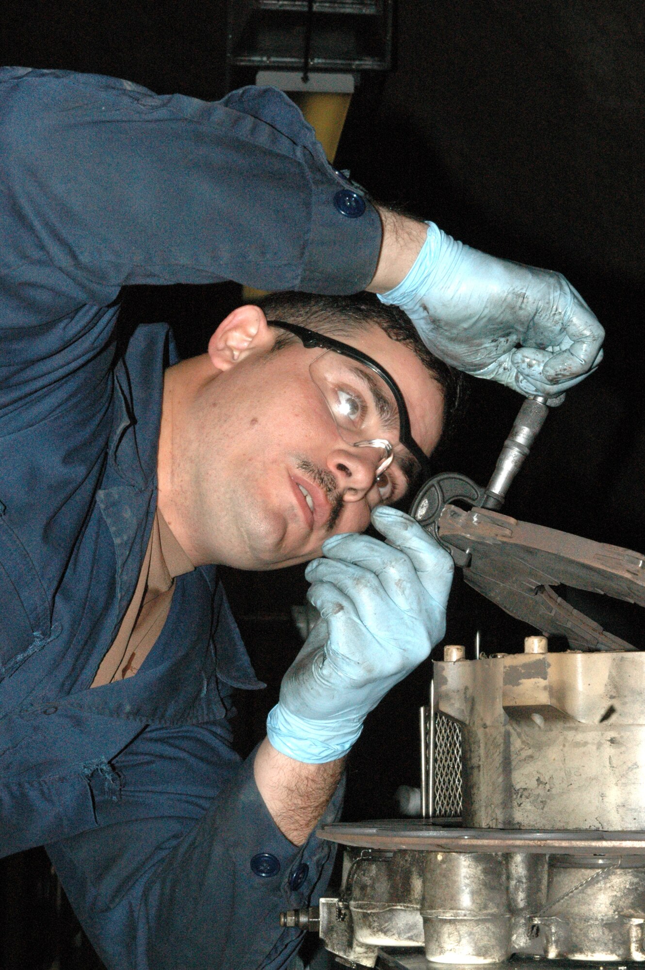 SOUTHWEST ASIA -- Sergeant Crespo measures the thickness of a new brake puck on a KC-135 brake here. The CIRF makes it possible for the brakes on KC-135s to be repaired immediately, saving time and money that would be spent shipping the parts to and from the United States. (U.S. Air Force photo/Senior Airman Carolyn Viss)
