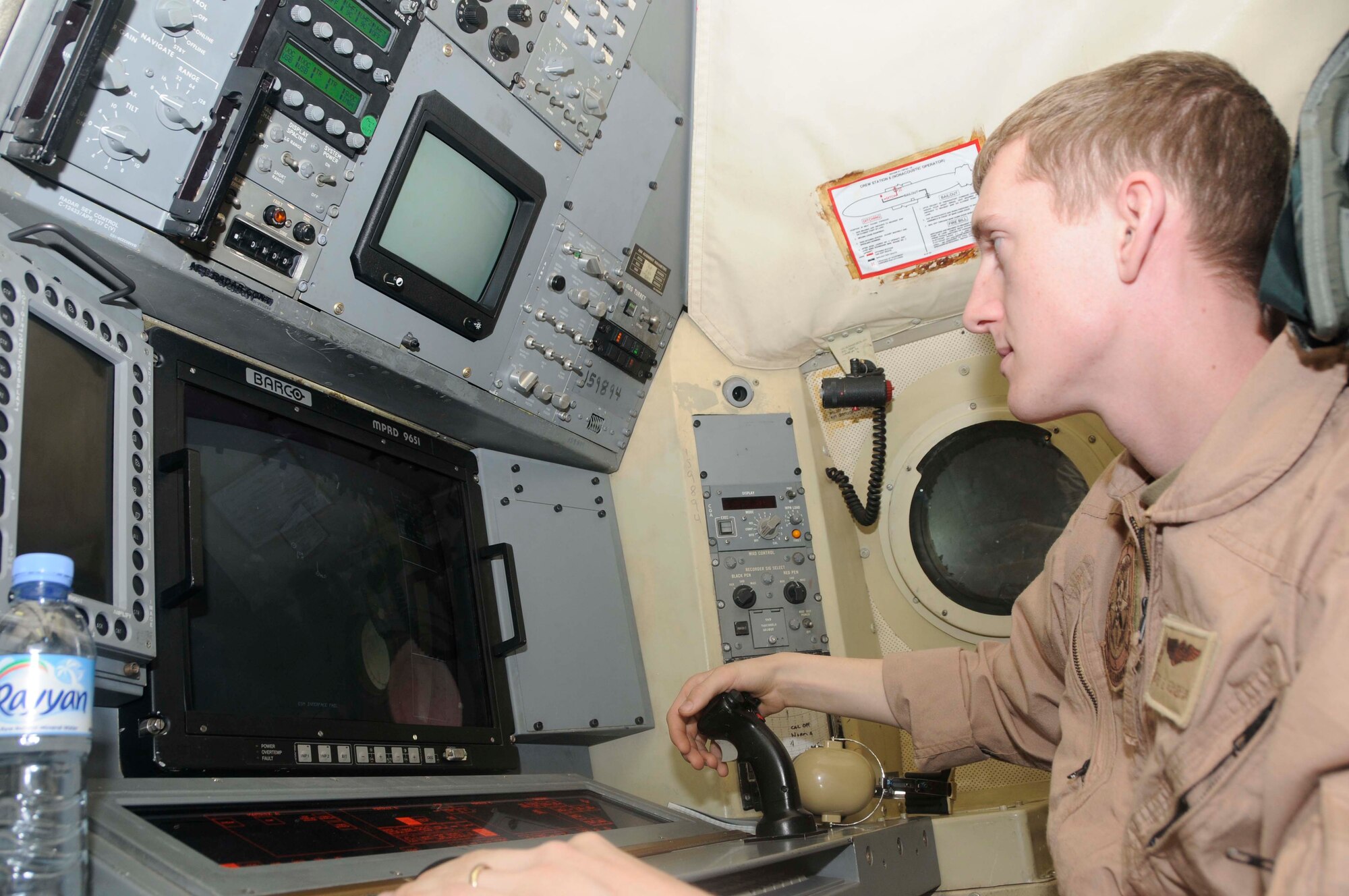 Navy Aviation Operator 2nd Class David Vaneman performs pre-flight checks on P-3 aircraft radar equipment before take off Feb. 26.  The maritime is a diverse element of the U.S. Navy whose missions include anti-submarine warfare and battlespace surveillance.  (U.S. Air Force photo/Senior Airman Domonique Simmons)