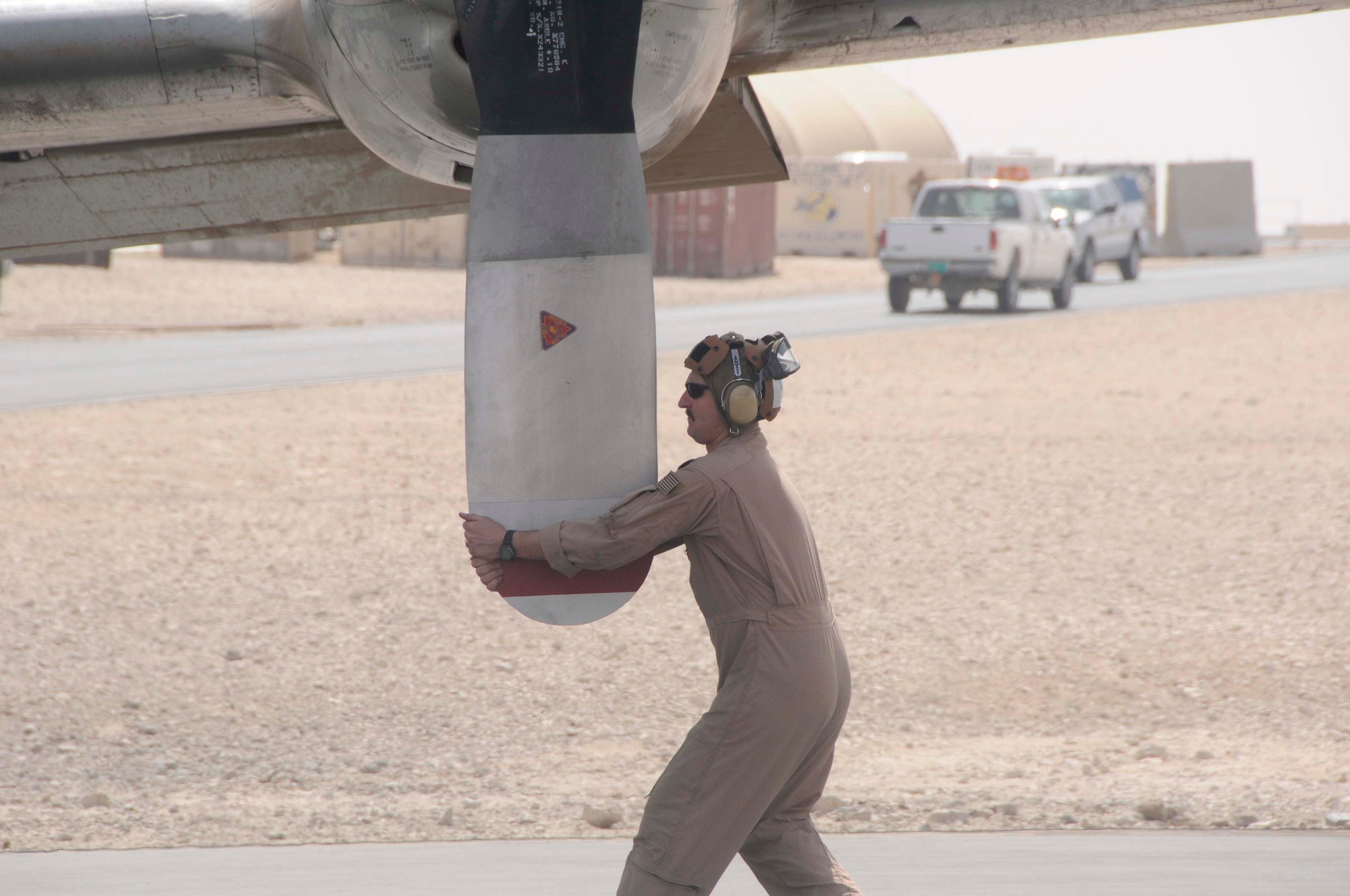 Navy Aircraft Structural Mechanic 1st Class Leo Mackin spins a propeller as part of a pre-flight check here Feb 26. He checks each of the four propellers for nicks, scratches and cracks prior to take off. (U.S. Air Force photo/Senior Airman Domonique Simmons)