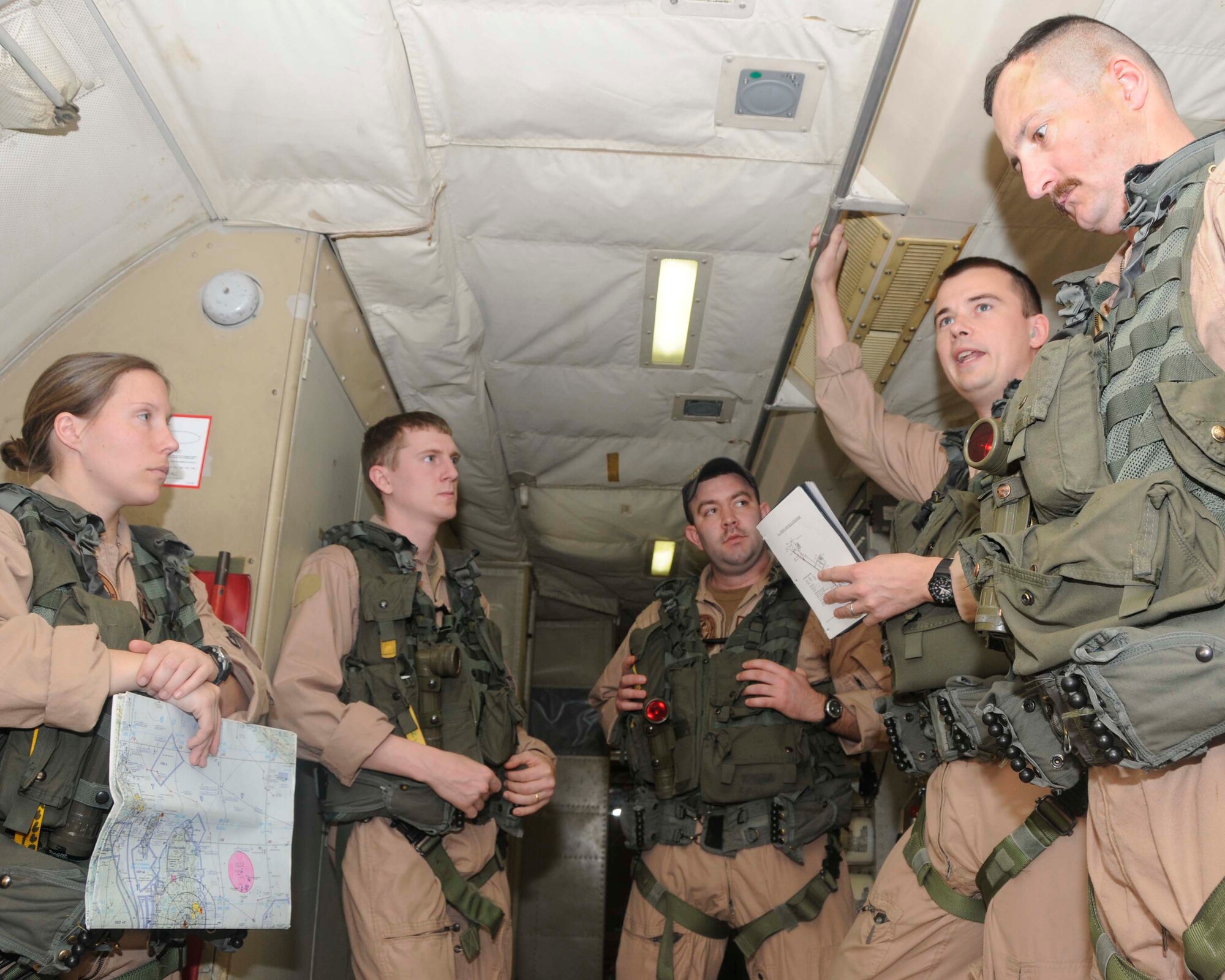 Navy Lt. Jed Magda, VP-26 Patrol Plane commander (second from right), gives an emergency procedures brief to crew members prior to their mission Feb. 26. (U.S. Air Force photo/Senior Airman Domonique Simmons)