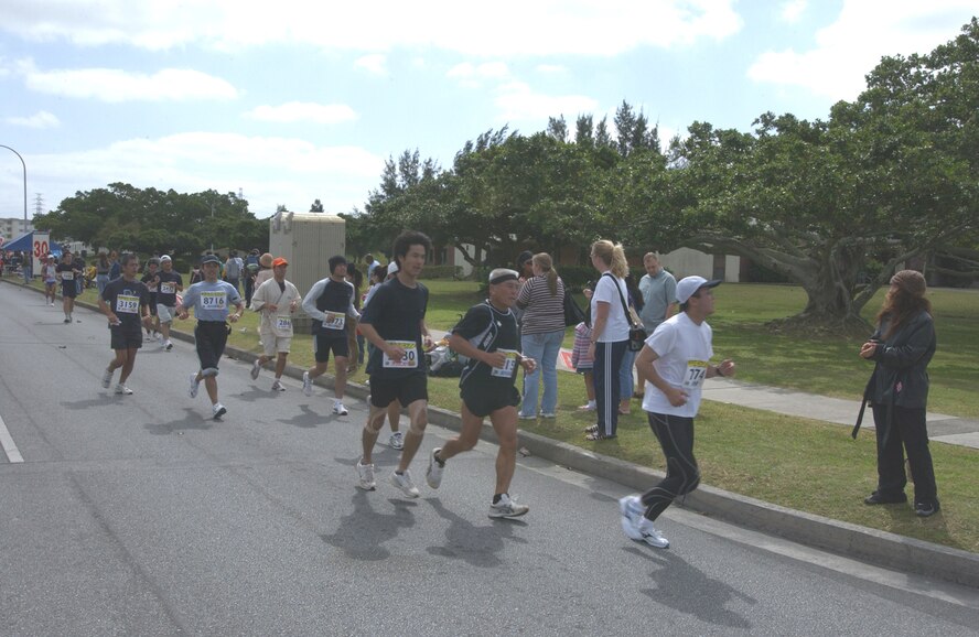 Competitors run the second half of the 16th Okinawa Marathon at Kadena.  Airmen and family members cheered and handed out water during the marathon.
More than 9,300 Okinawan and Japanese runners participated in the marathon. These runners are just passing the 30-kilometer point. (U.S. Air Force photo/Senior Airman Jeremy McGuffin)     
