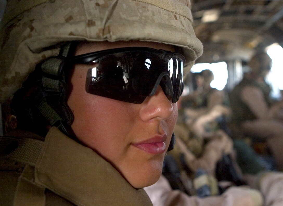 Marine Lance Cpl. Ashley R. Ramirez rides on a Ch-46 Sea Knight helicopter during a flight to Al Asad Air Base, Iraq, July 9, 2007. 