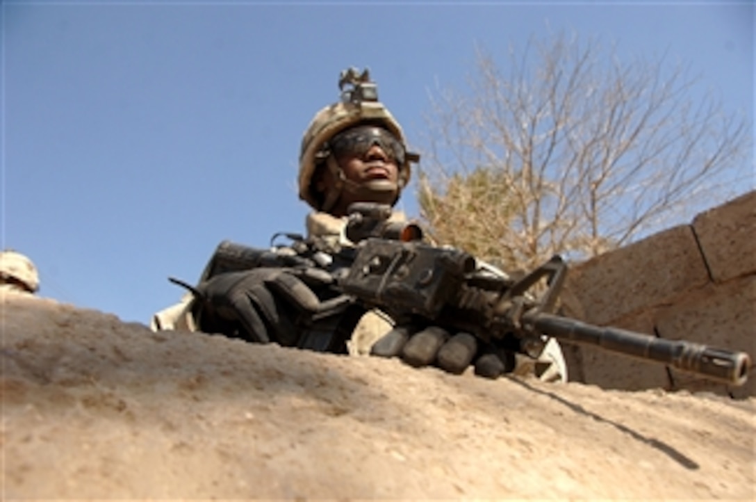 U.S. Army Spc. Mishel Francois from Bravo Company, 1st Battalion, 15th Infantry Regiment, 3rd Heavy Brigade Combat Team, 3rd Infantry Division provides security during a patrol in Dura'iya, Iraq, on Feb. 23, 2008.  The village was recently occupied by insurgents.  