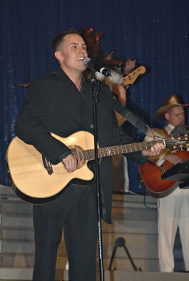 Senior Airman Benjamin Taylor performs a Jonny Cash song during a Tops in Blue performance Dec. 29, 2007, at Misawa Air Base, Japan. Tops in Blue is on tour performing "The Fly-By", a musical tribute to 60 years of proud Air Force History. (U.S. Air Force photo by Airman 1st Class Benjamin Wilson)