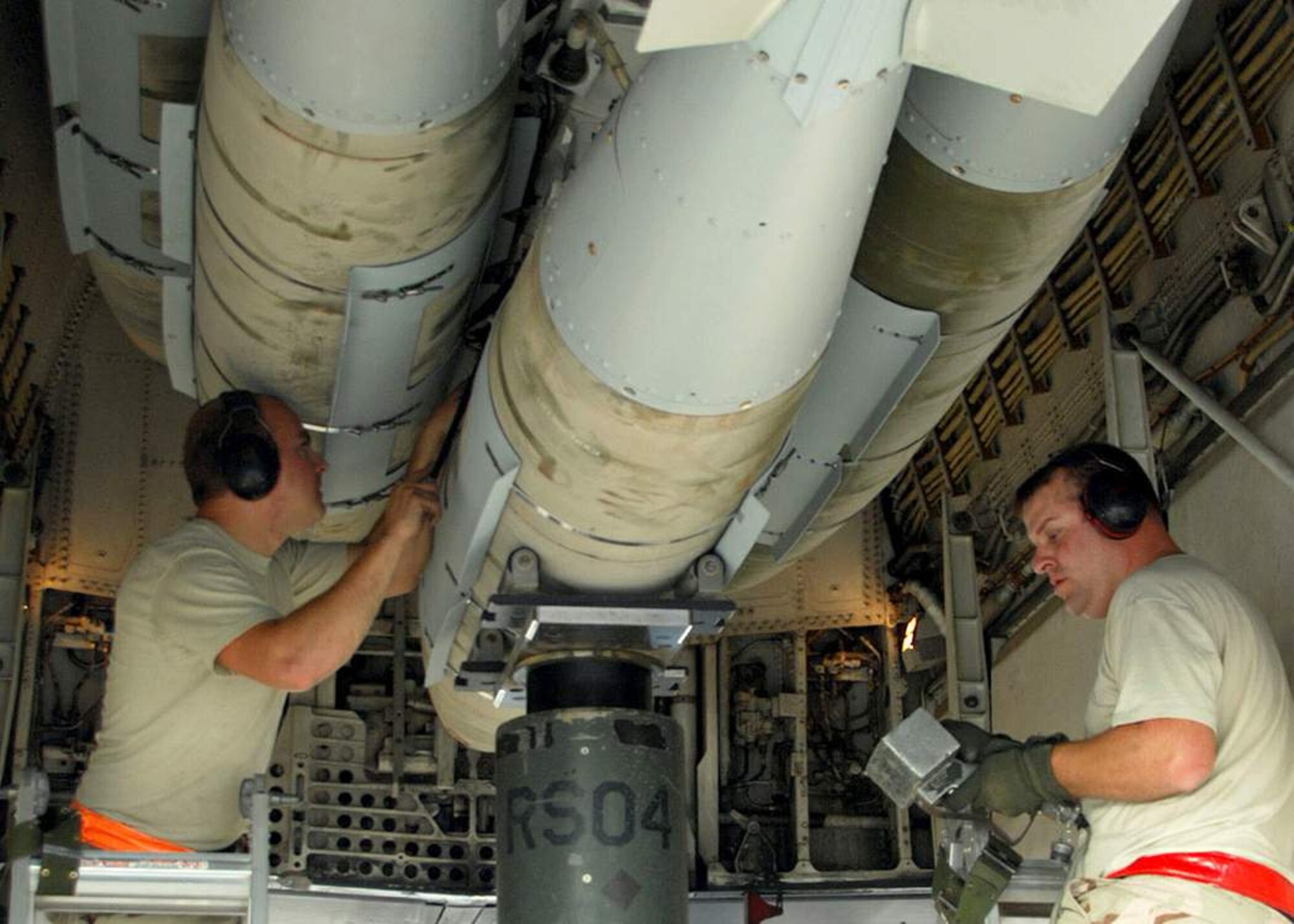 Staff Sgt. Brandon Neitz and Tech. Sgt. James Sheldon load 2,000-pound bombs on an Air Force B-1B Lancer in preparation for a mission in support of Operation Enduring Freedom. The B-1B can rapidly deliver massive quantities of precision and non-precision weapons on specific targets. (U.S. Air Force photo/Staff Sgt. Douglas Olsen)
