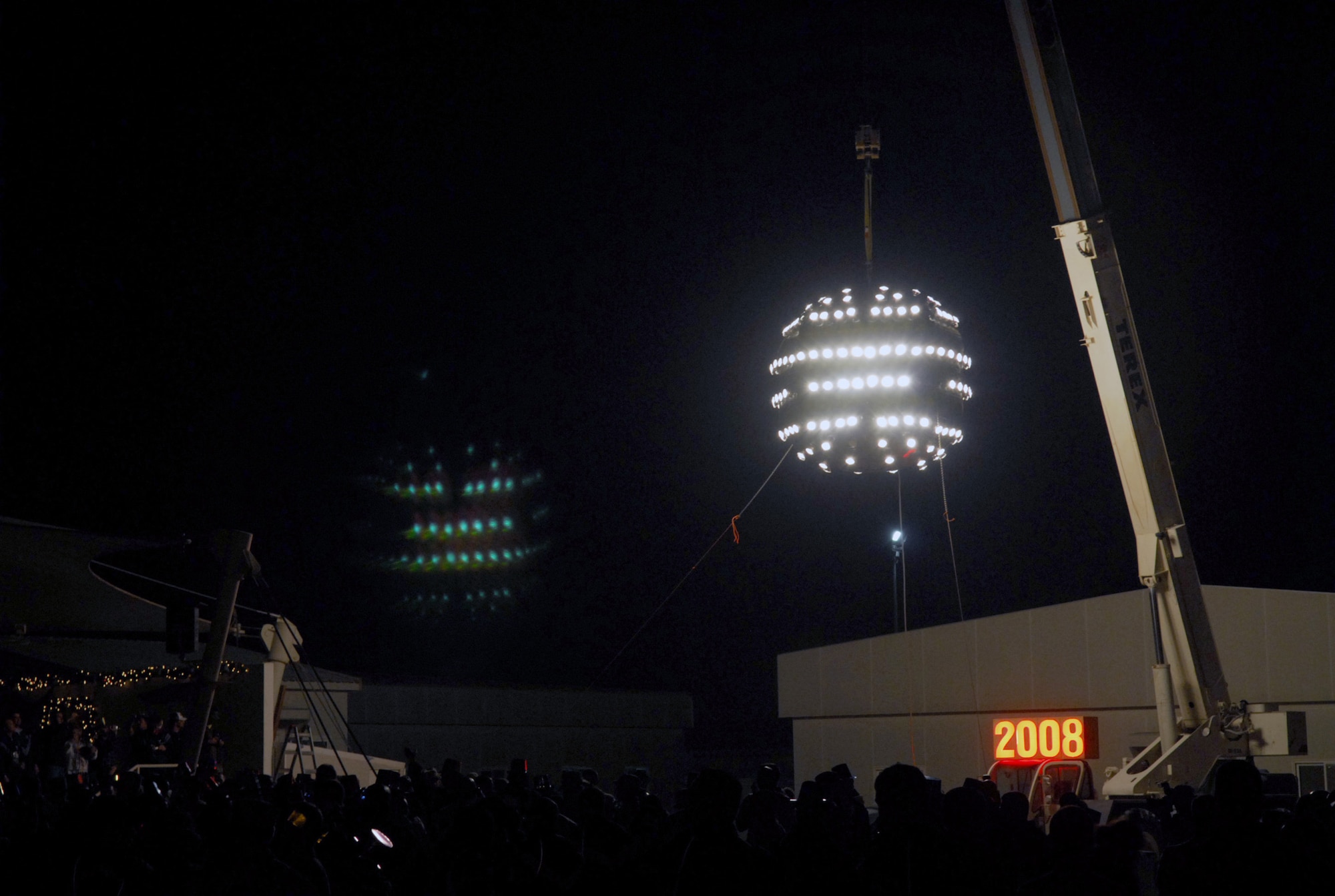 SOUTHWEST ASIA - Members of the 379th Air Expeditionary Wing and coalition forces here gathered for a New Year's Eve celebration to usher in 2008. A lighted ball, constructed by members of the 379th Expeditionary Civil Engineer Squadron is lowered to signify the end of 2007. (U.S. Air Force photo/Staff Sgt. Douglas Olsen)