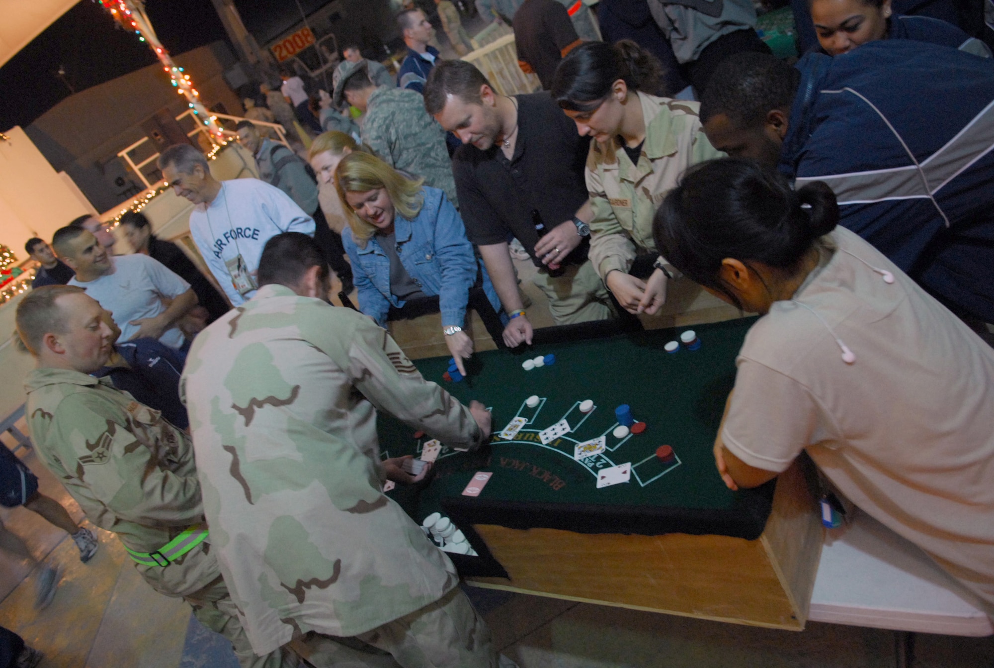 SOUTHWEST ASIA - Master Sgt. Kenneth Ramirez deals Black Jack at a New Year's Eve celebration here Dec. 31. The 379th Air Expeditionary Wing rang in the New Year with a casino night theme and a traditional ball drop a la Times Square. (U.S. Air Force photo/Staff Sgt. Douglas Olsen)