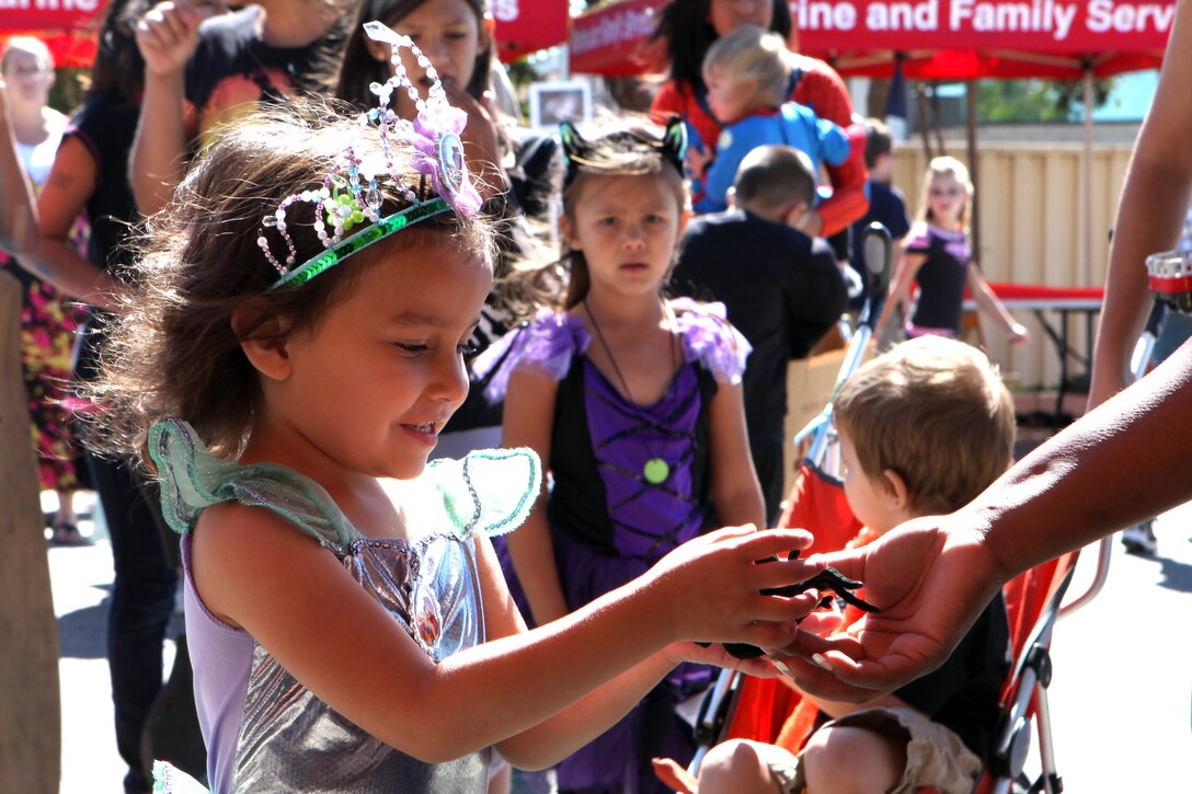 CAMP PENDLETON, Calif. - Dressed up in their Halloween costumes, children wait in line to play carnival-style games at the Marine & Family Program’s Haunted Harvest Festival at the Abby Reinke Community Center here, Oct. 8.