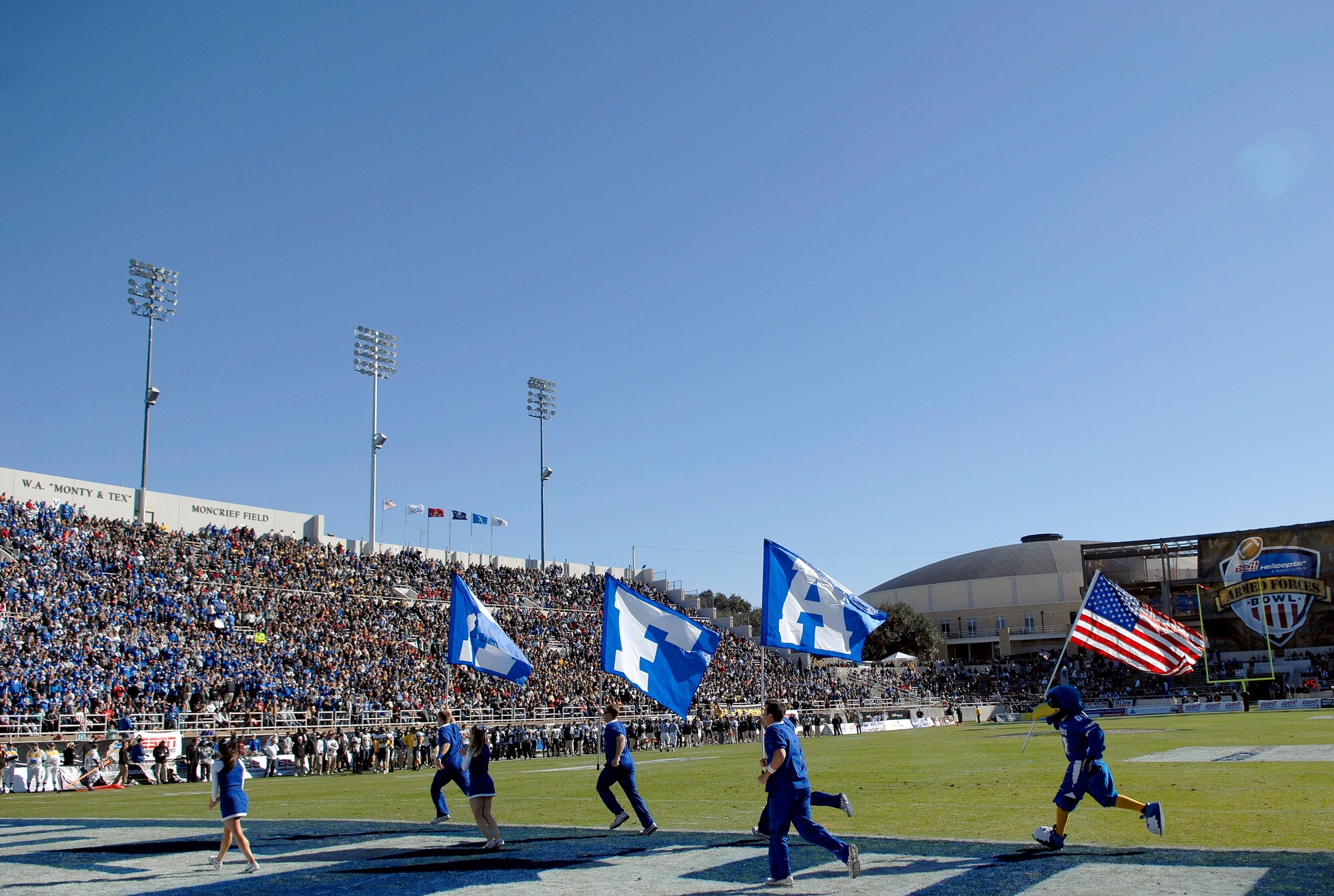 The U.S. Air Force Academy cheer squad takes to the field to fire up the sellout crowd of the Amon G. Carter stadium, after a second quarter touchdown by the Air Force during the Bell Helicopter Armed Forces Bowl game Dec. 31 in Ft. Worth, Texas. (U.S. Air Force photo/Staff Sgt. Bennie J. Davis III)