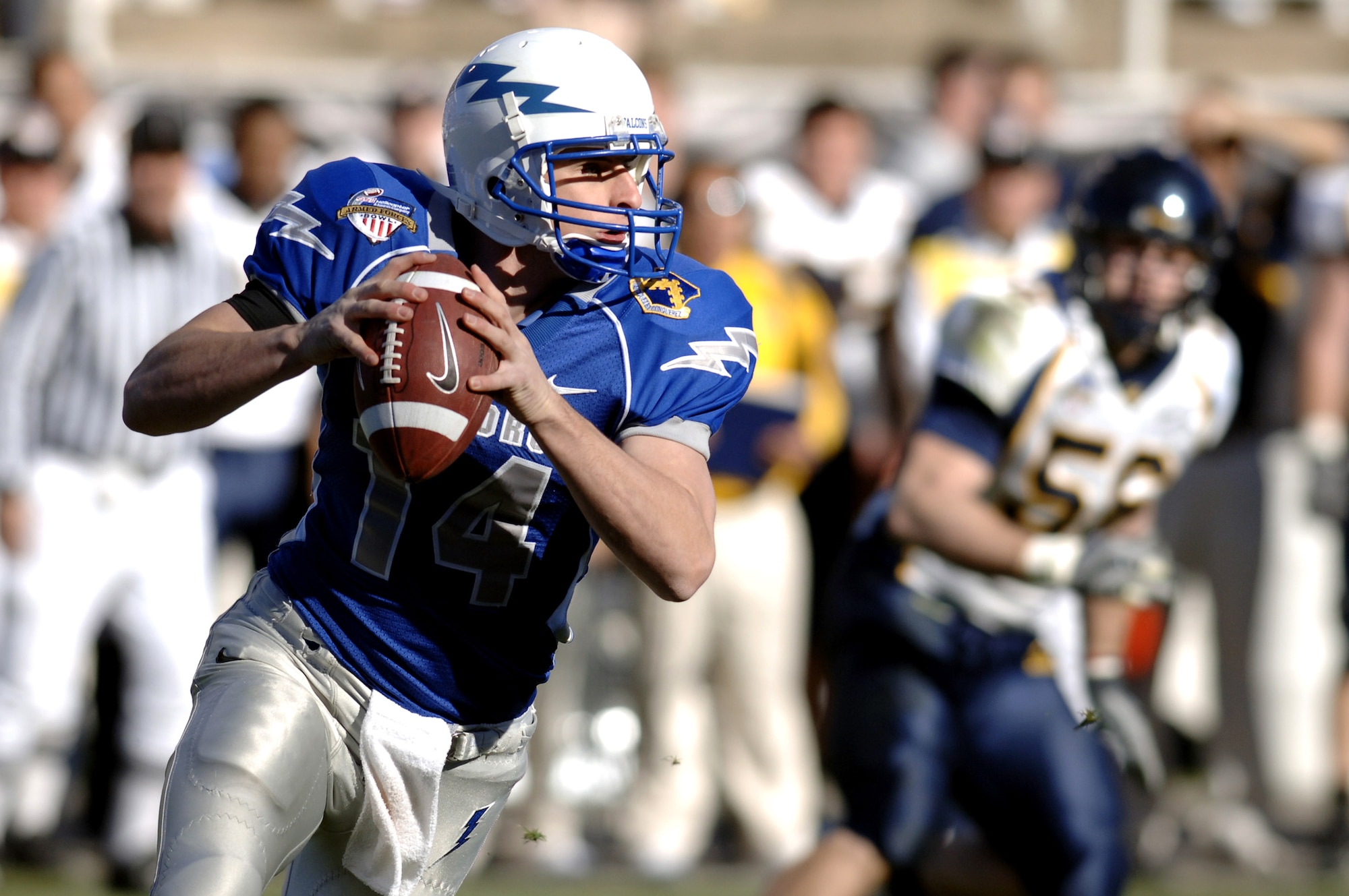 Junior quarterback Shea Smith is flushed from the pocket by the California defense.  Smith ran four times for 33 yards and completed four passes for 45 yards against the California Golden Bears in the Bell Helicopter Armed Forces Bowl at Amon G. Carter Stadium Dec. 31. (U.S. Air Force photo/Mike Kaplan)