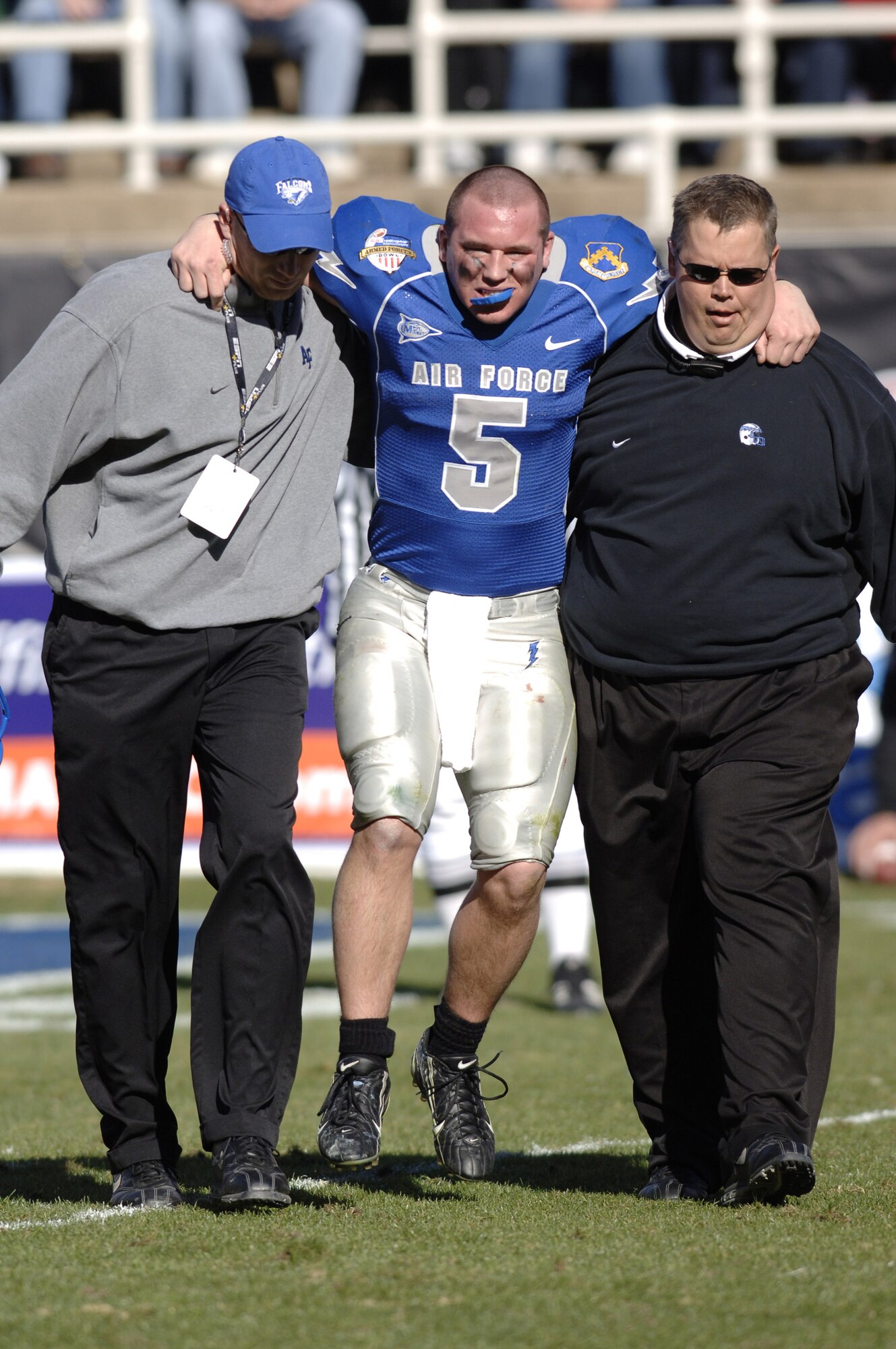 Senior quarterback Shaun Carney is assisted off the field after injuring his right knee late in the third quarter against the California Golden Bears in the Bell Helicopter Armed Forces Bowl at Amon G. Carter Stadium Dec. 31. The Falcons lost 42-36 in their first bowl appearance since 2002 before a bowl record 40,905 fans and a nationally televised audience.  (U.S. Air Force photo/Mike Kaplan)