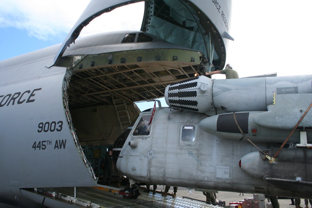 The 445th Airlift Wing's C-5 aircraft transports two Marine CH53 Helicopters from Oahu, Hawaii to South Korea Dec. 14, 2007.  From the Navy to the Marines the 445th Airlift Wing delivers to the total force.  (U.S. Air Force photo/Mary Allen)  