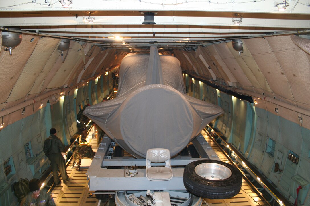 The 445th Airlift Wing's C-5 aircraft transports the Advance SEAL Delivery System (ASDS), a type of Navy submarine, from McChord AFB, Wash., to its final destination, Pearl Harbor, Dec. 12, 2007.  The weight of the cargo tips the scales for the wing's heaviest move.  (U.S. Air Force photo/Mary Allen)  