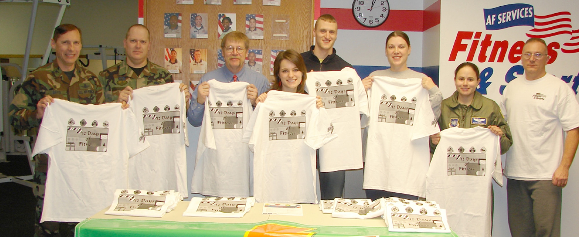 Participants in the "12 Days of Fitness" received T-shirts for completing the fitness challenge. Pictured from left to right are Col. Roderick Davis, Staff Sgt. David Walkters, Pete Woelkers, Katie Schneider, Joe Schneider, Tech. Sgt. Shelly Foster, 1st Lt. Kathleen Tenpenny and Tech. Sgt. Ron Lambert.  Other finishers not pictured include 1st Lt. K.C. Hebner, Airman Nicholas Hunt and Sally Smith. (U.S. Air Force photo)