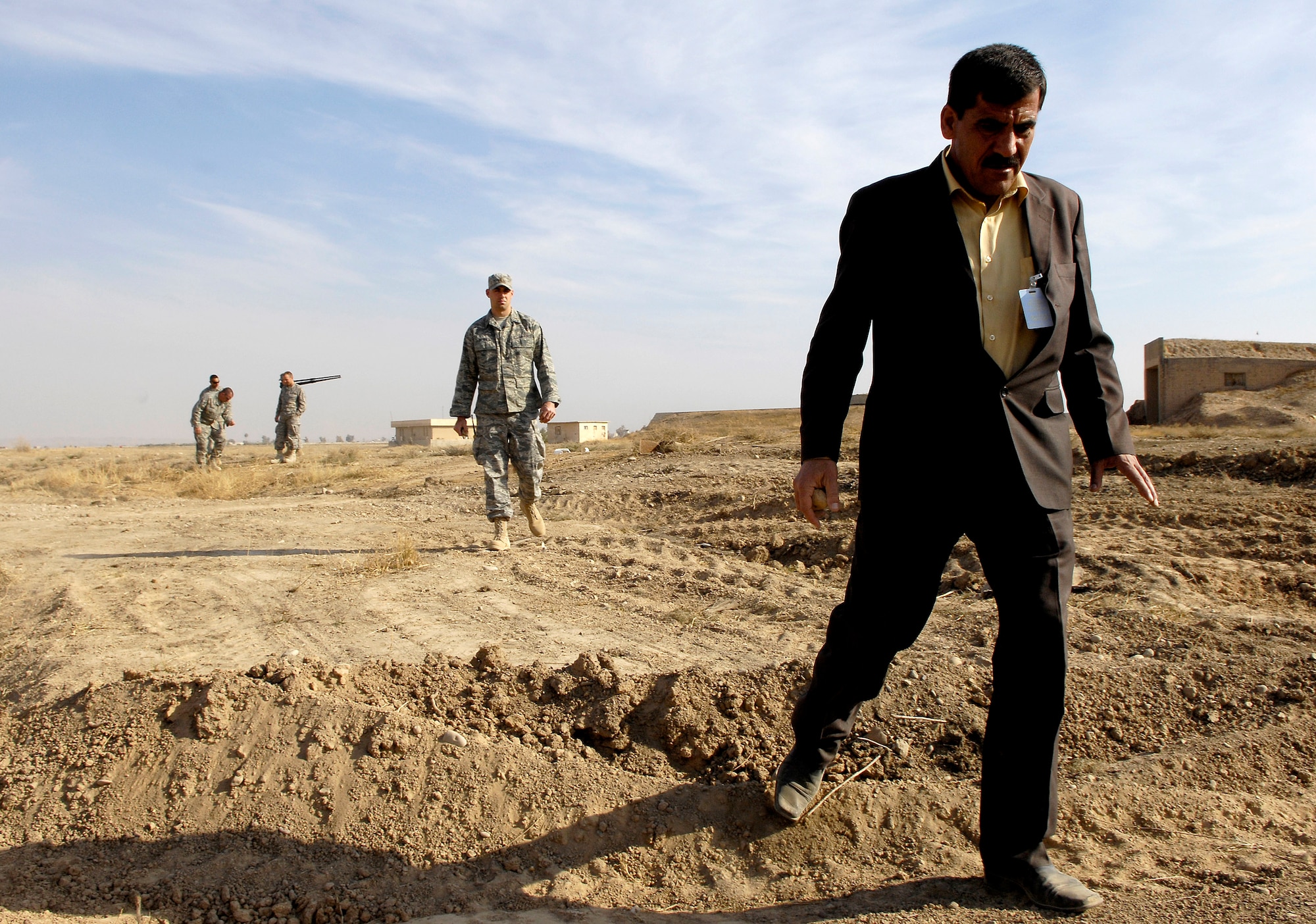 S.M. Ameen and 2nd Lt. Brian Wernle look over one of four Kirkuk Air Base, Iraq, construction sites Dec. 26 where artifacts were found. The artifacts at this site were discovered by civil engineering Airmen while grading an area near the flightline. Mr. Ameen is a local Iraqi archeologist and the assistant curator at the Kirkuk Museum. Lieutenant Wernle is the base environmental engineer with the 506th Expeditionary Civil Engineer Squadron. (U.S. Air Force photo/Staff Sgt. Brian Ferguson)