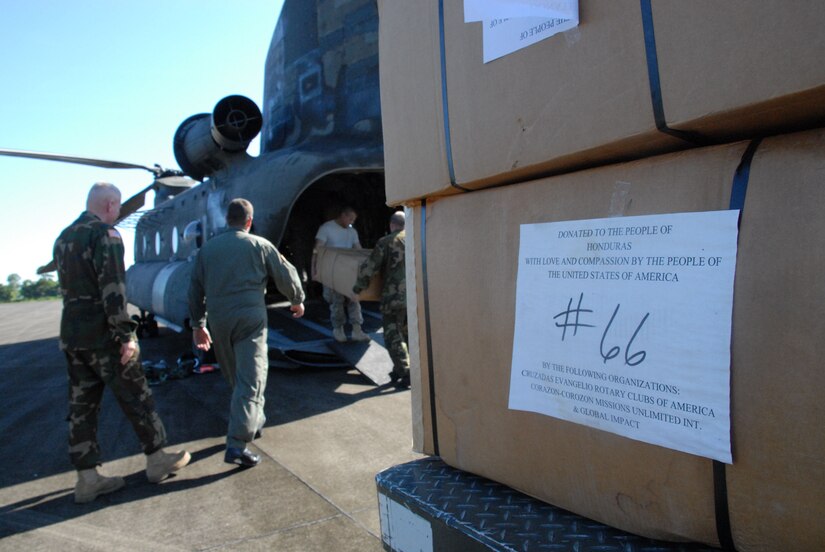 LA CEIBA, Honduras - Soldiers and Airmen from Joint Task Force-Bravo at Soto Cano Air Base, Honduras, offload donated wheelchairs from a CH-47 Chinook helicopter here Dec. 28.  The hand-crank wheelchairs were donated to isolated villages along the Miskito Coast of Honduras.  The Alabama non-profit organization Missions Unlimited contacted the U.S. Agency for International Development to coordinate the donation. (U.S. Air Force photo by Tech. Sgt. Sonny Cohrs) 