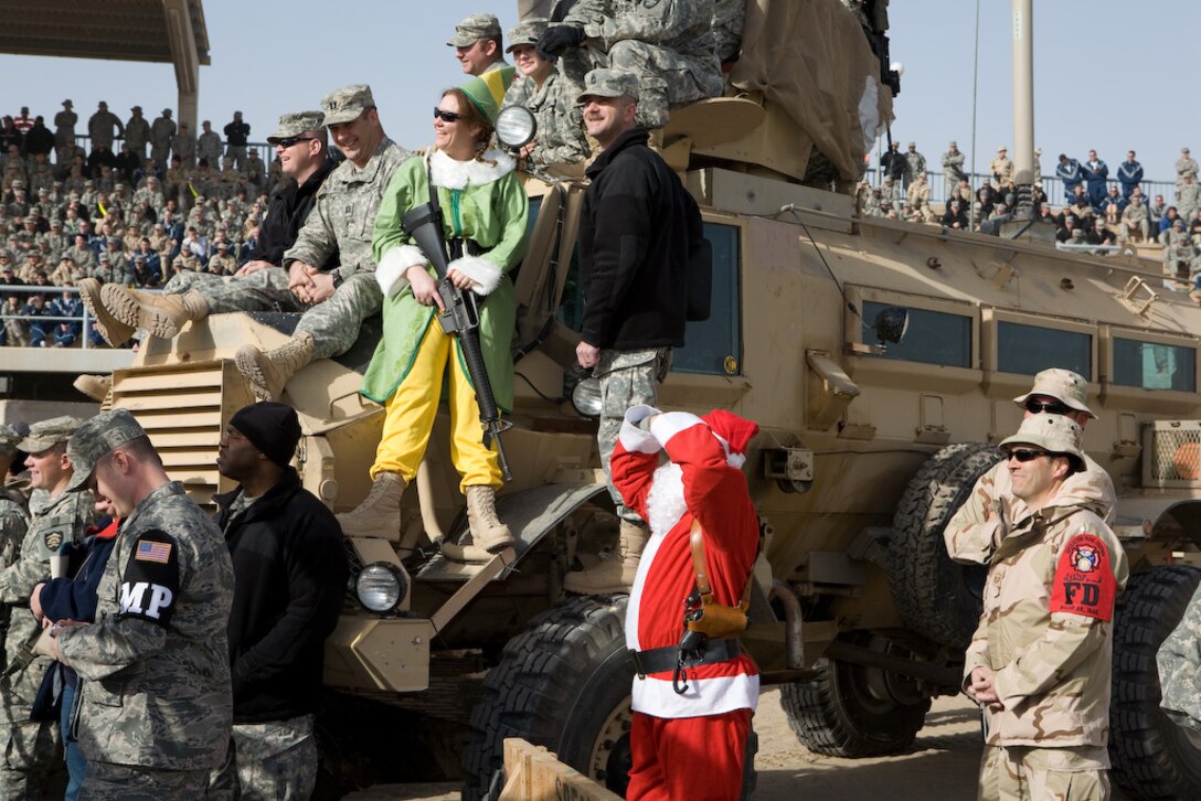 SEYMOUR JOHNSON AIR FORCE BASE, N.C -- A well-armed Santa and his elves meet and greet the troops in Iraq. Lt. Col. James Horton, 916th Communications Squadron commander, is currently deployed there.