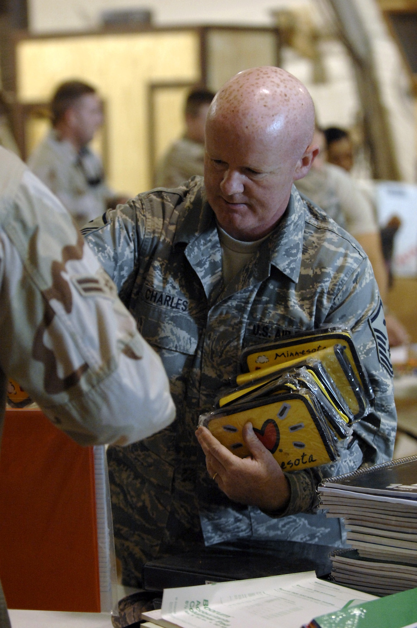 Master Sgt. Stephen Charles hands out school supplies in support of Operation Iraqi Child at Ali Base, Iraq, Dec. 22. In just over a month, Airmen on base collected thousands of school supply items, soccer balls, stuffed animals and toys from family and friends in the U.S. Airmen from the 407th Air Expeditionary Group sorted through the donated items which will be given to Iraqi families in the An Nasiriyah area villages. Sergeant Charles is assigned to the 407th Expeditionary Civil Engineer Squadron and is deployed from Hickam Air Force Base, Hawaii. (U.S. Air Force photo/Airman 1st Class Jonathan Snyder) 

