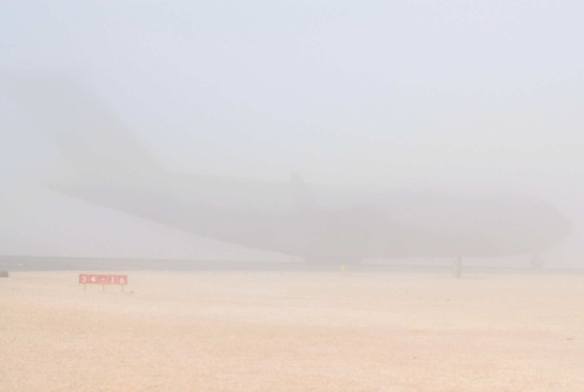 SOUTHWEST ASIA - A C-17 Globemaster 3 lands on the foggy runway of a Southwest Asia air base Jan. 1. The C-17 is capable of rapid delivery of troops and all sorts of cargo to main operating bases or directly to forward operating bases as required. (U. S. Air Force photo/Staff Sgt. Douglas Olsen)