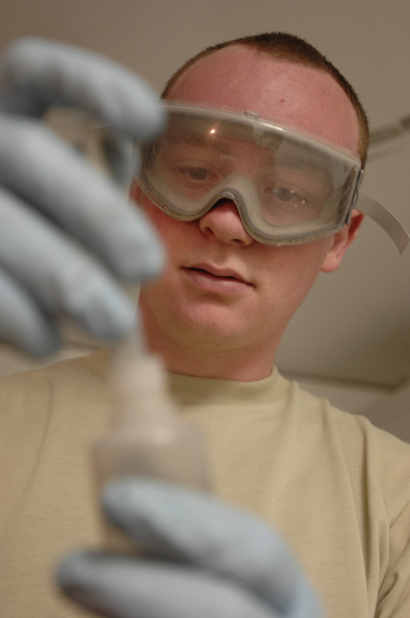 ALI AIR BASE, Iraq -- Senior Airman Jay Pickle extracts a small amount of mixture to help lower the freezing point of the water and fuel to prevent the fuel from freezing during flight Dec. 28. A sample of fuel must be tested for every fuel shipment received to ensure the quality meets the strict standards to be used in Air Force aircraft. He is assigned to the 407th Expeditionary Logistics Readiness Squadron and is deployed from Yokota Air Base, Japan. (U.S. Air Force photo/Airman 1st Class Jonathan Snyder) (Released)