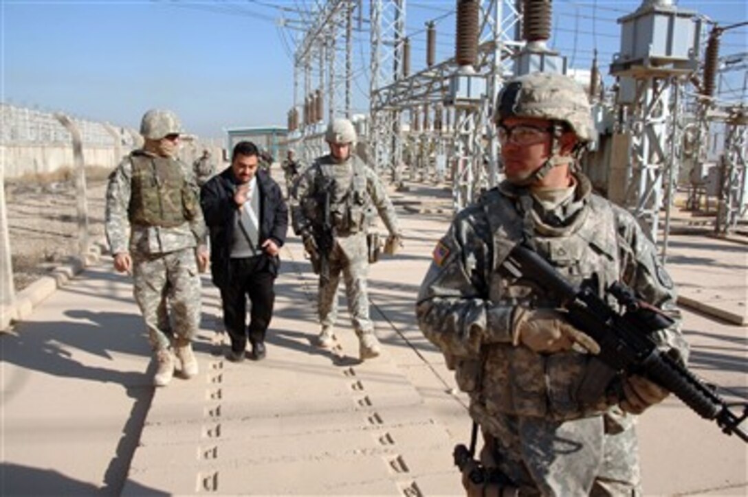 U.S. Army soldiers meet with the manager of a power plant in Mosul, Iraq, on Dec. 27, 2007. Soldiers attached to the 3rd Armored Cavalry Regiment are assessing how they can assist with bringing the plant to operational capability.  