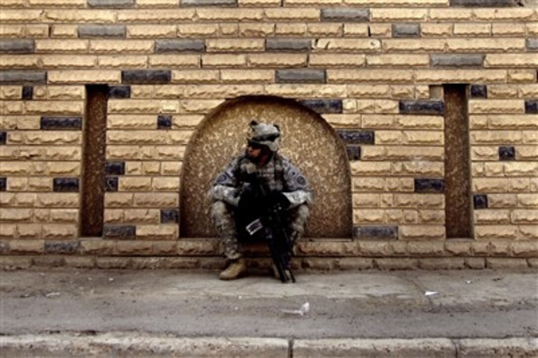 U.S. Army Sgt. Thomas Calavera sits in a niche as he takes a moment to relax during a presence patrol in the Dora District of Baghdad, Iraq, on Dec. 28, 2007.  Calavera is attached to the 2nd Squadron, 2nd Stryker Cavalry Regiment.  