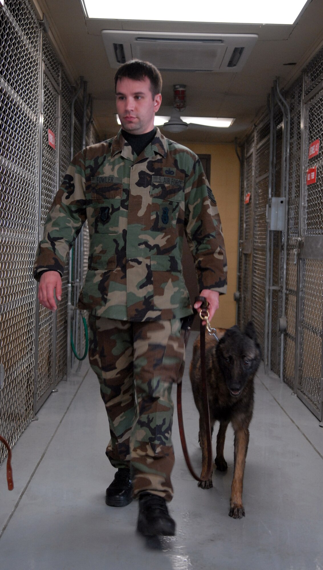 KUNSAN AIR BASE, South Korea -- Staff Sgt. Robert Fowler walks his partner, Rico, back to his kennel at the newly renovated  military working dog facility here Dec. 28.  Sergeant Fowler and members of the 8th Security Forces Squadron’s K-9 unit train and work side-by-side with K-9s as part of their duties.   (U.S. Air Force photo / Senior Airman Steven R. Doty)