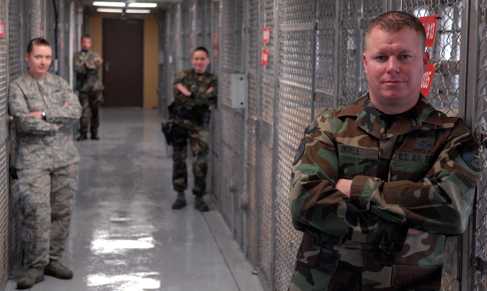 KUNSAN AIR BASE, South Korea -- Members of the 8th Security Forces Squadron’s K-9 unit pose for a portrait at the newly renovated military working dog facility here Dec. 28.  The 8th SFS K-9 unit train and work side-by-side with K-9s as part of their duties.  (U.S. Air Force photo/Senior Airman Steven R. Doty)