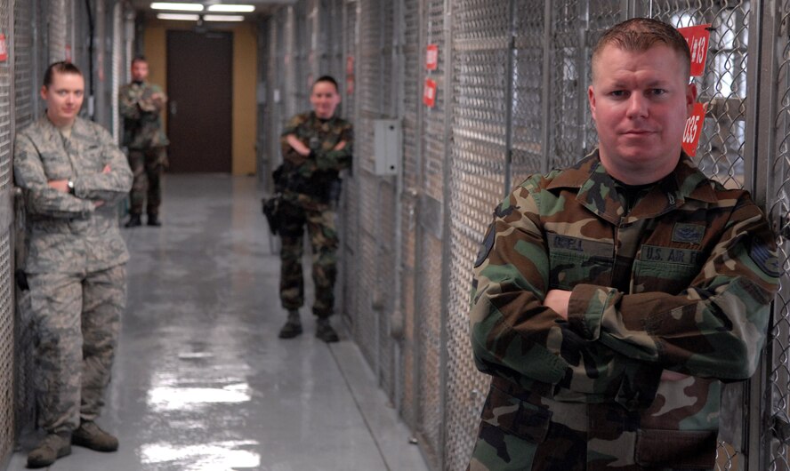 KUNSAN AIR BASE, South Korea -- Members of the 8th Security Forces Squadron’s K-9 unit pose for a portrait at the newly renovated military working dog facility here Dec. 28.  The 8th SFS K-9 unit train and work side-by-side with K-9s as part of their duties.  (U.S. Air Force photo/Senior Airman Steven R. Doty)