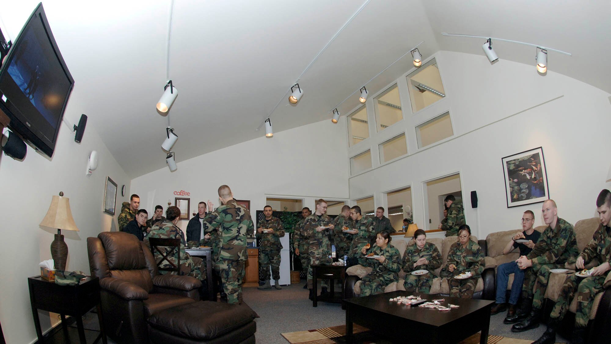 FAIRCHILD AIR FORCE BASE, Wash. – Fairchild Airmen enjoy the theater room in the Airman’s Lounge at the reopening on Dec. 21. The facility received approximately $40,000 for a face lift during a six week renovation. The facility was upgraded to ensure Airmen have a nice place to socialize and gather. (U.S. Air Force photo /Staff Sgt. JT May III)