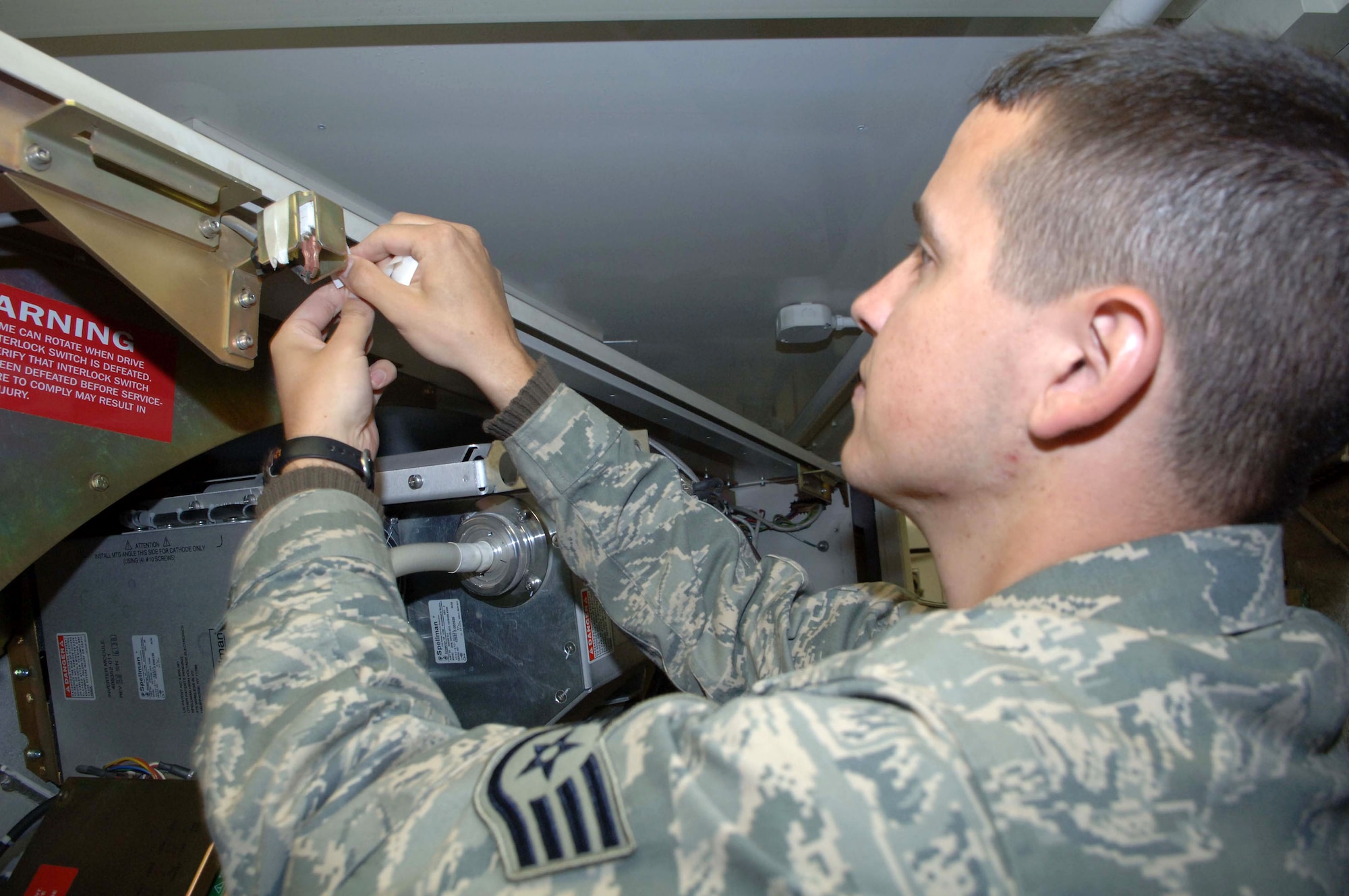 Staff Sgt. Orlando Ortega covers the power switch on a computerized tomography machine Dec. 31 at the Air Force Theater Hospital at Balad Air Base, Iraq. Sergeant Ortega is deployed from Barksdale Air Force Base, La. (U.S. Air Force photo/Senior Airman Terri Barriere)