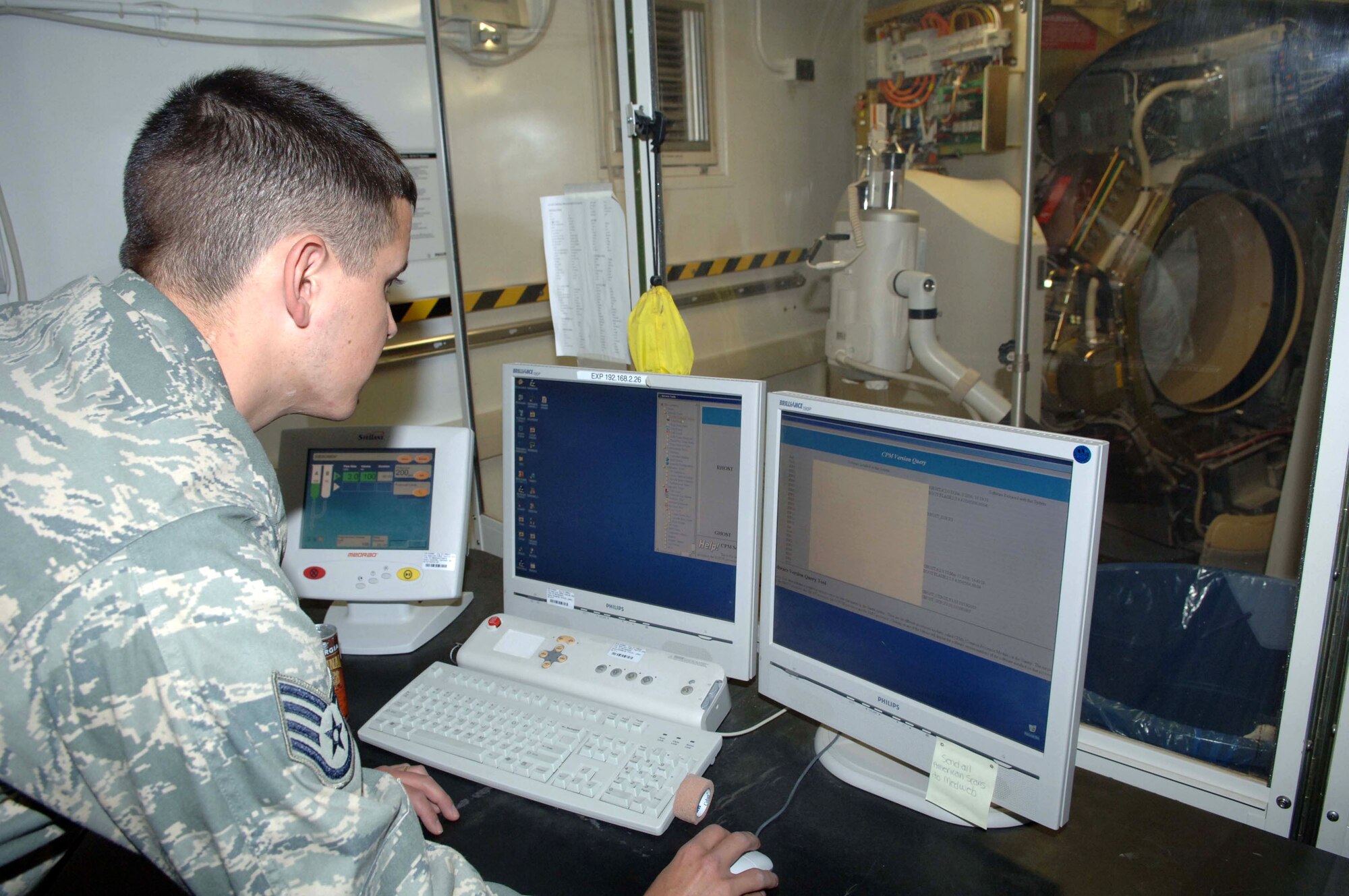Staff Sgt. Orlando Ortega uses a computer to troubleshoot a computerized tomography machine Dec. 31 at the Air Force Theater Hospital at Balad Air Base, Iraq. Sergeant Ortega is a 332nd Expeditionary Medical Support Squadron biomedical equipment technician deployed from Barksdale Air Force Base, La. (U.S. Air Force photo/Senior Airman Terri Barriere)