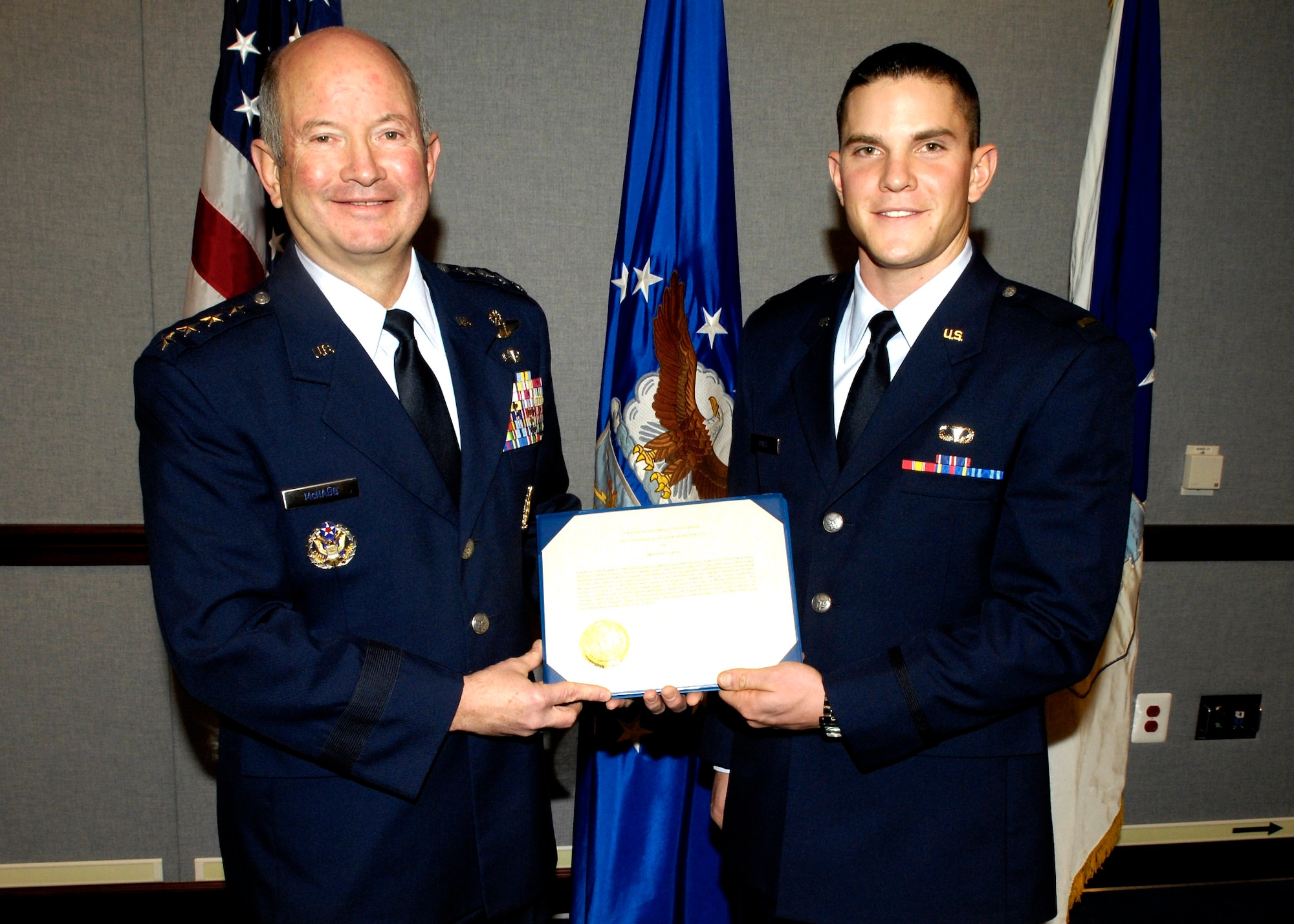 Vice Chief of the Staff of the Air Force Gen. Duncan J. McNabb presents 2nd Lt. Brandon T. Dues with the 2007 Cadet of the Year Award. The award recognizes the most outstanding cadet in an Air Force commissioning program.  Lieutenant Dues graduated from the Air Force Academy last May.  (U.S. Air Force photo/Donna Parry)