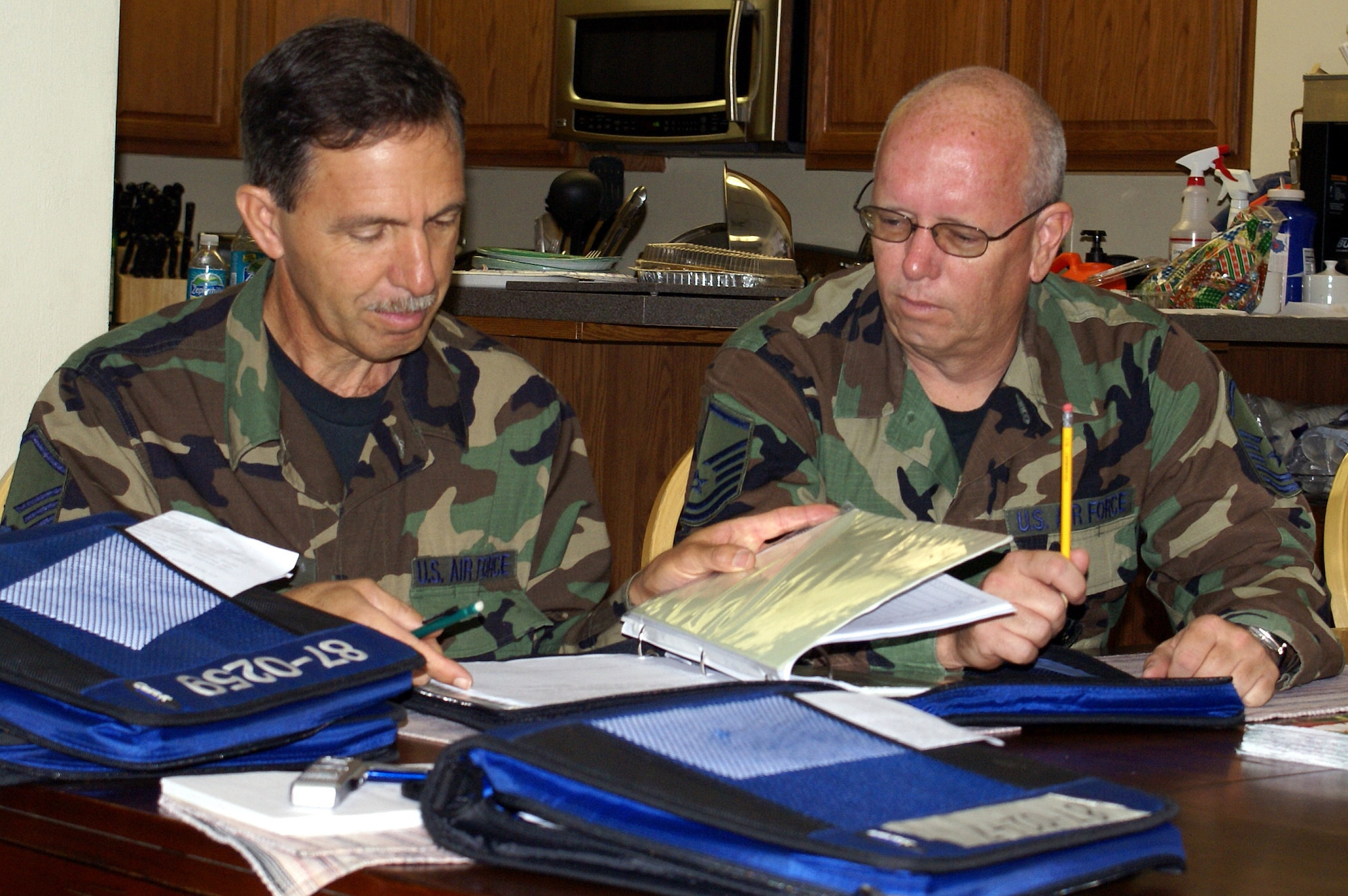 Master Sgt. Angel Hidalgo, 482nd Aircraft Maintenance Squadron flight chief, and Master Sgt. James Tant, 482nd Maintenance Squadron weapons loader, review paperwork at the North American Aerospace Defense Command (NORAD) alert facility at Homestead Air Reserve Base. Homestead pilots, maintainers and support personnel have volunteered to temporarily support “Operation Noble Eagle” with F-16 fighter jets in lieu of a detachment of Florida Air National Guardsmen based out of the 125th Fighter Wing, Jacksonville, Fla. The Guardsmen are normally assigned to the mission and fly and maintain F-15A fighter jets from Homestead ARB, but the entire Air Force fleet of about 670 F-15A through F-15D model fighter jets was grounded due to precautionary testing for airworthiness problems on Nov. 2. (U.S. Air Force photo/Senior Airman Erik Hofmeyer)