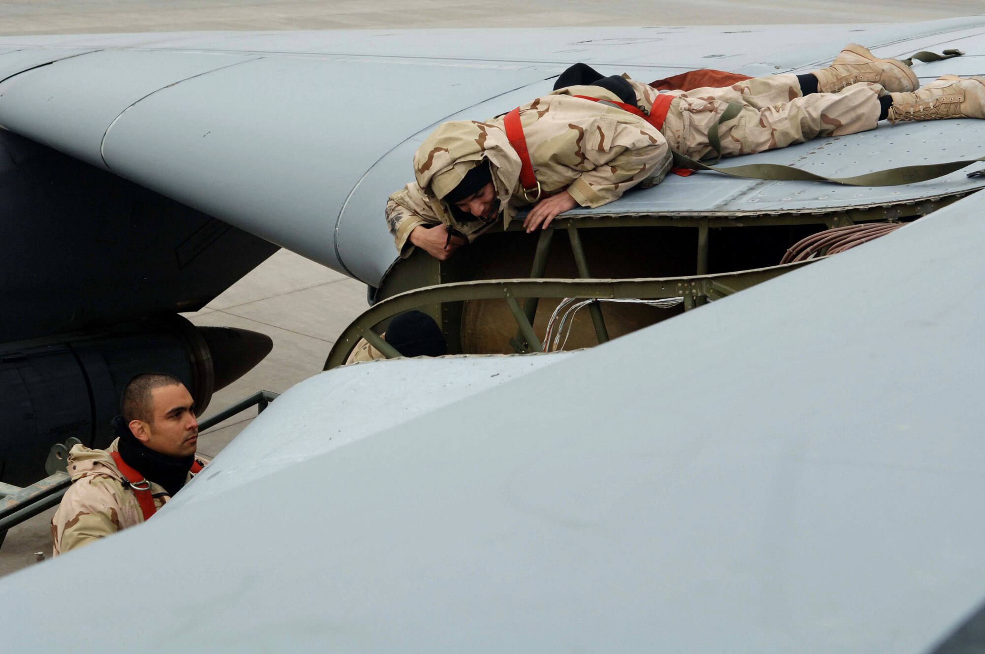 Staff Sgt. Roger Vasquez and Airman 1st Class Chris Olmstead look inside a C-5 Galaxy in search of a mechanical malfunction. The C-5 is the largest airlifter in the Air Force and has the ability to carry 36 standard pallets and up to 81 troops simultaneously. Both Airmen are crew chiefs from the 721st Air Mobility Operations Group and are deployed from Travis Air Force Base, Calif. (U.S. Air Force photo/Senior Airman Terri Barriere)