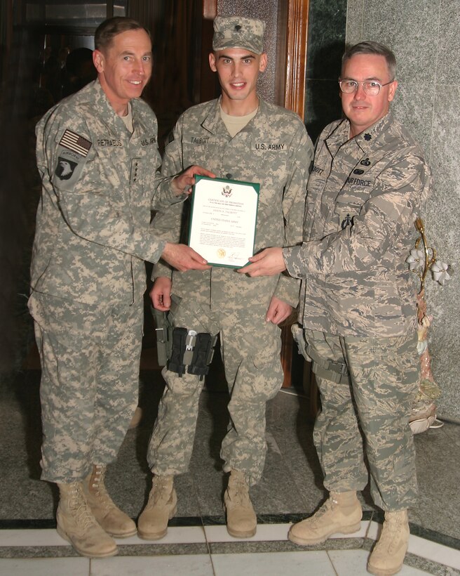 Gen. David H. Petraeus, commanding general of Multi-National Force-Iraq, poses with Army Specialist Jason Talbott and Jason’s father, Lt. Col. Bret Talbott, after Specialist Talbot's promotion ceremony Dec.24. Both father and son are deployed to Camp Victory in Baghdad, Iraq. Colonel Talbott, who’s deployed from Langley, is currently attached to the Joint NetOps Control Center, an element of Multi-National Forces Iraq; and Specialist Talbot, who’s deployed from Fort Lewis, Wash., serves as a combat medic attached to General Petraeus’ staff. (U.S. Air Force photo/Lt. Col. J.C. Sorensen)